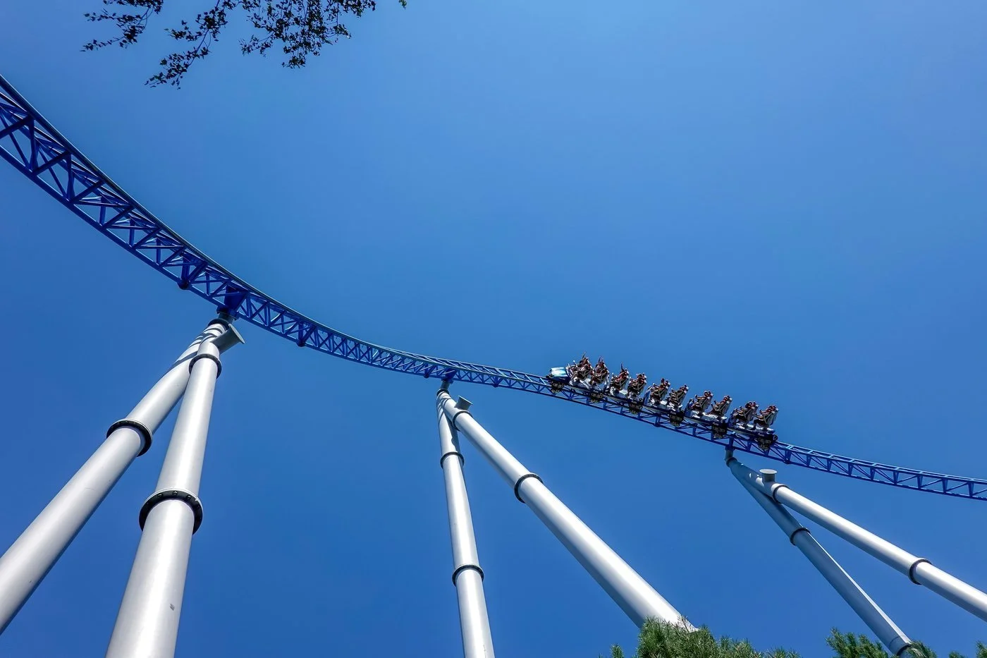 Rollercoaster against blue sky — representing the extreme volatility risk of leveraged ETFs for long-term investors.