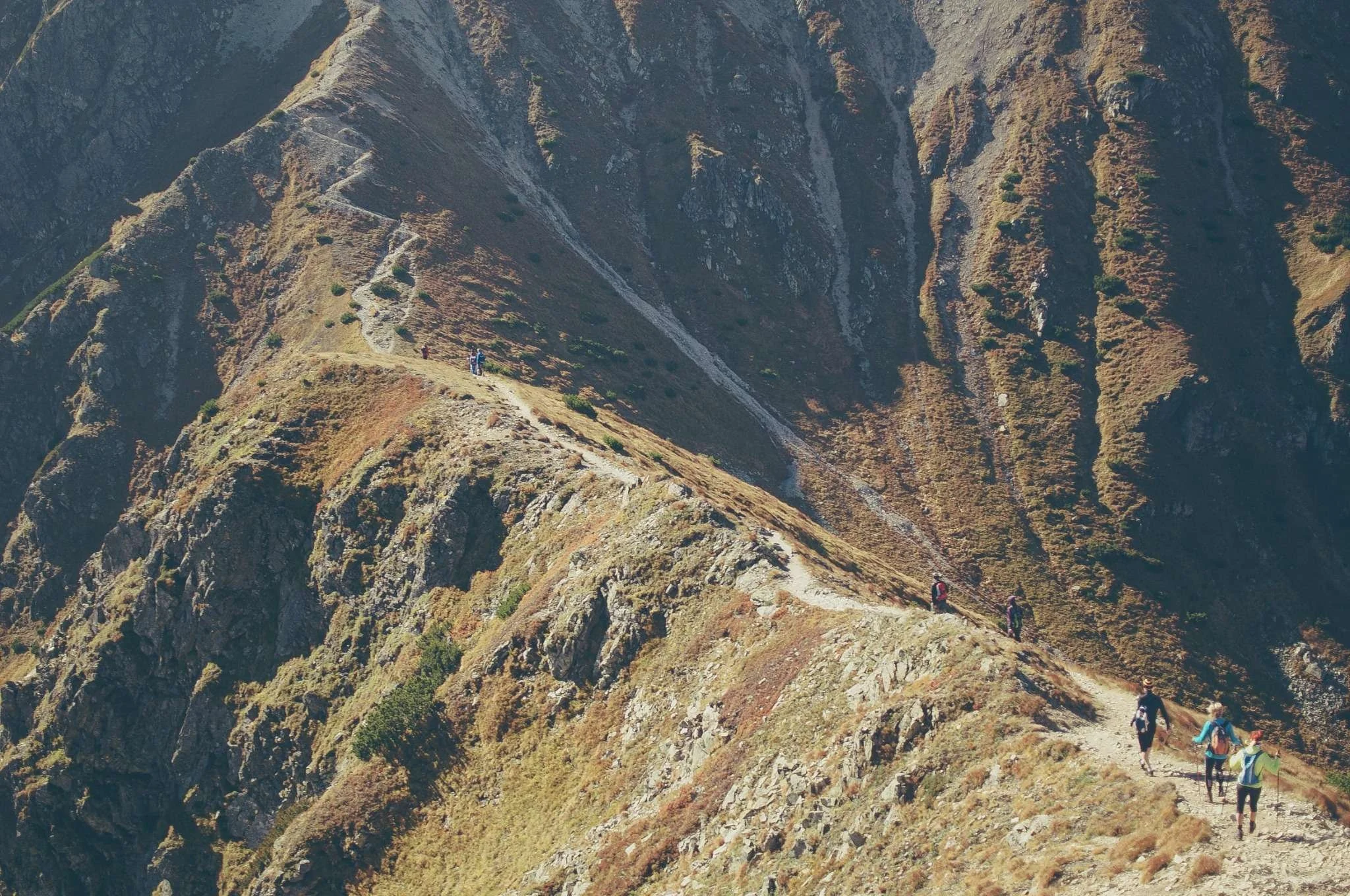 Hikers walking along a mountain ridge trail symbolizing the journey and challenges of Financial Independence.
