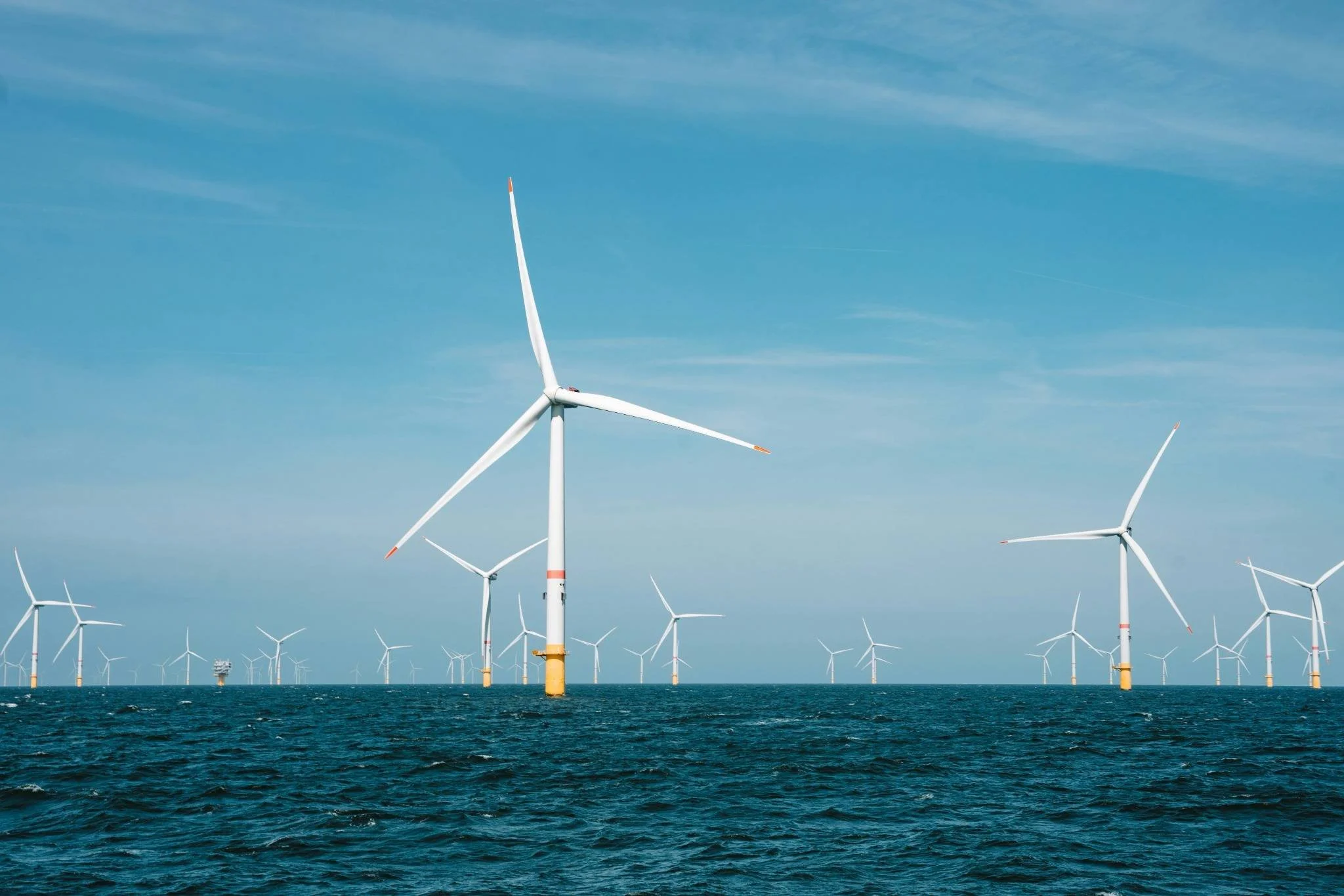 Offshore wind farm turbines representing clean energy infrastructure.