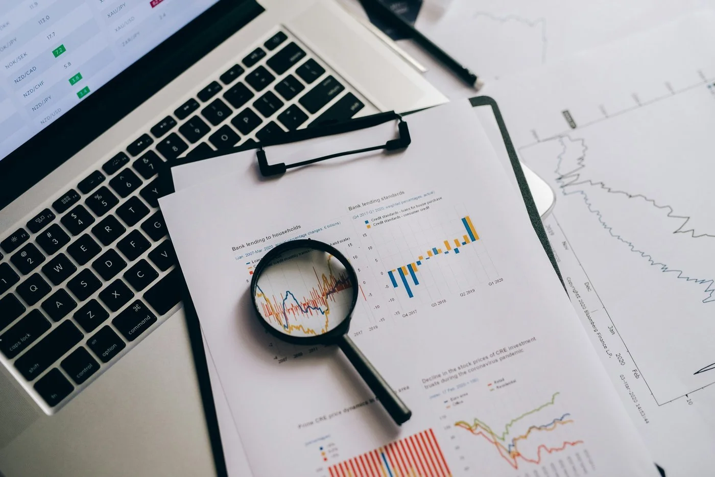 Magnifying glass over financial charts and data — representing careful examination of where dividend investing has a defensible role for FIRE investors.