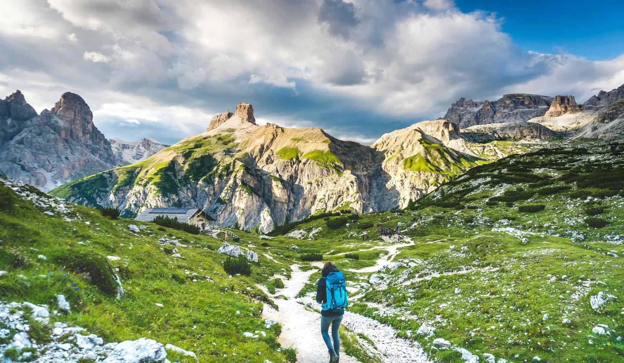 Woman hiking mountain trail symbolizing journey to Financial Independence and healthy retirement.