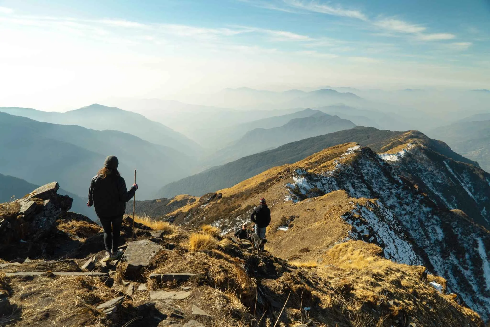 Hikers in mountain landscape representing sustainable lifestyle and time freedom.