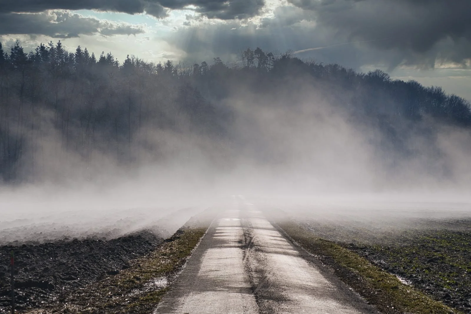 Empty road disappearing into fog, representing the uncertainty of predicting stock market returns over the next decade.