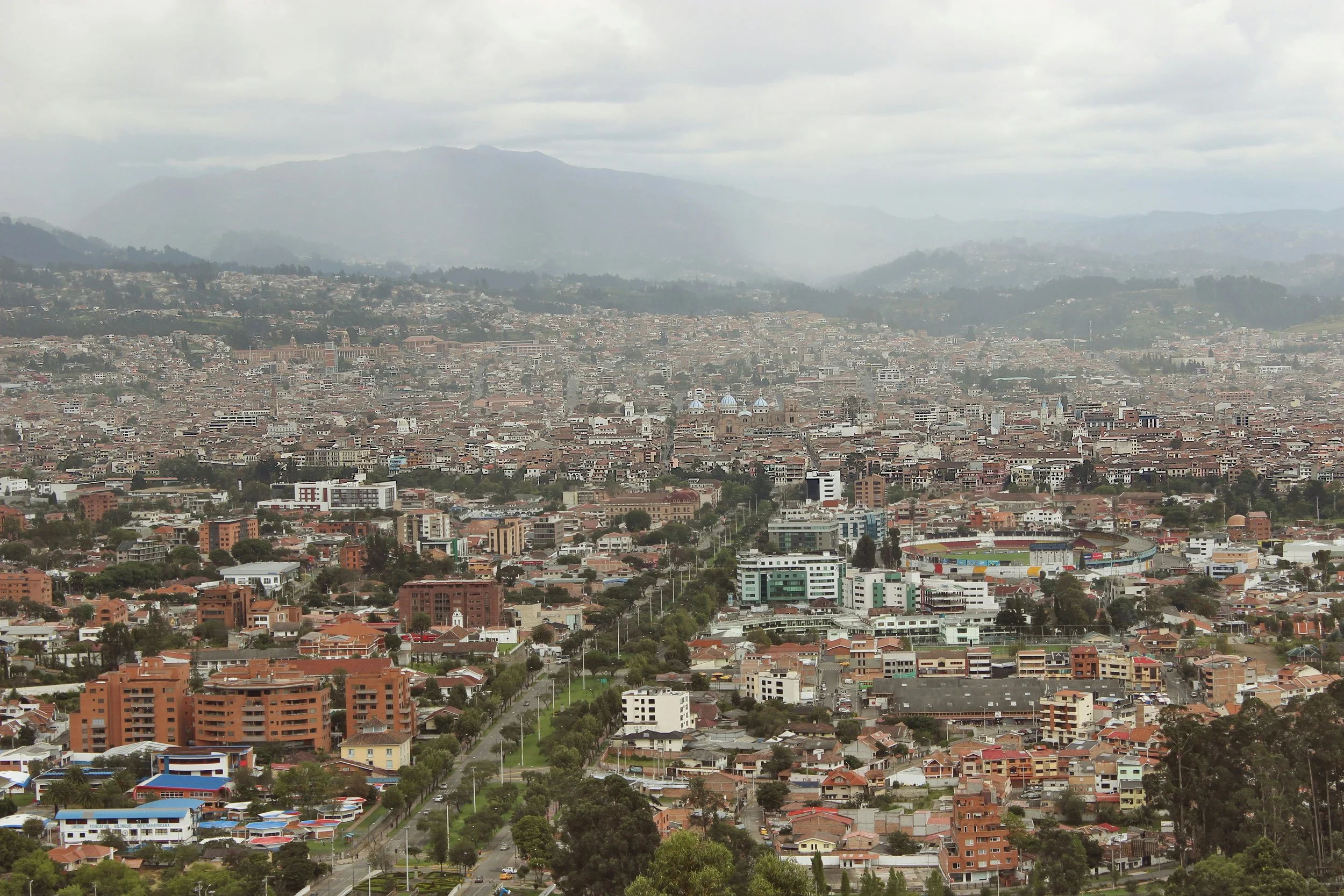 Aerial view of Cuenca in the Ecuadorian Andes under low cloud, a high-altitude city with 3,415 comfortable outdoor hours a year