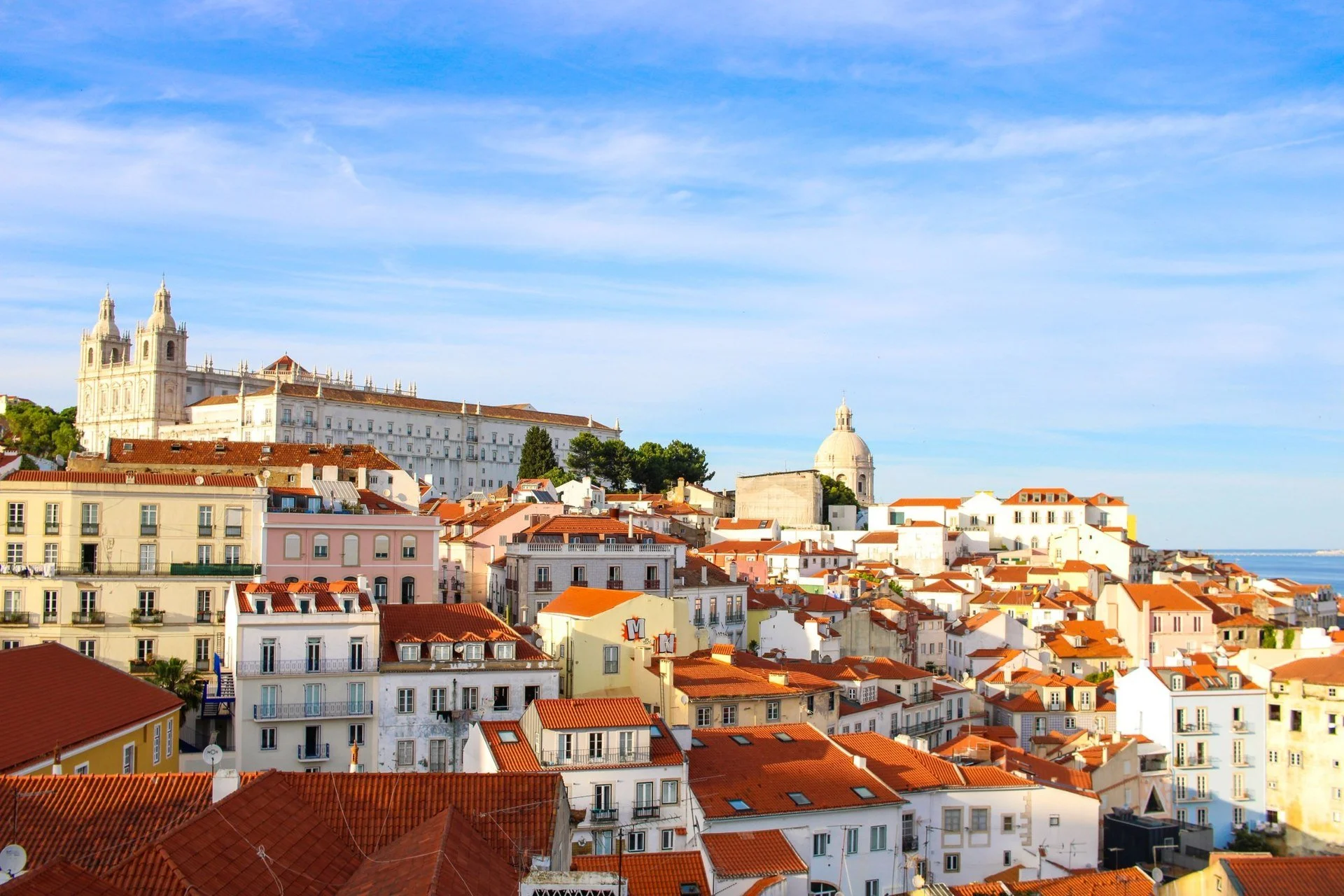 View over the terracotta rooftops of the Alfama district in Lisbon, Portugal, toward the Tagus river
