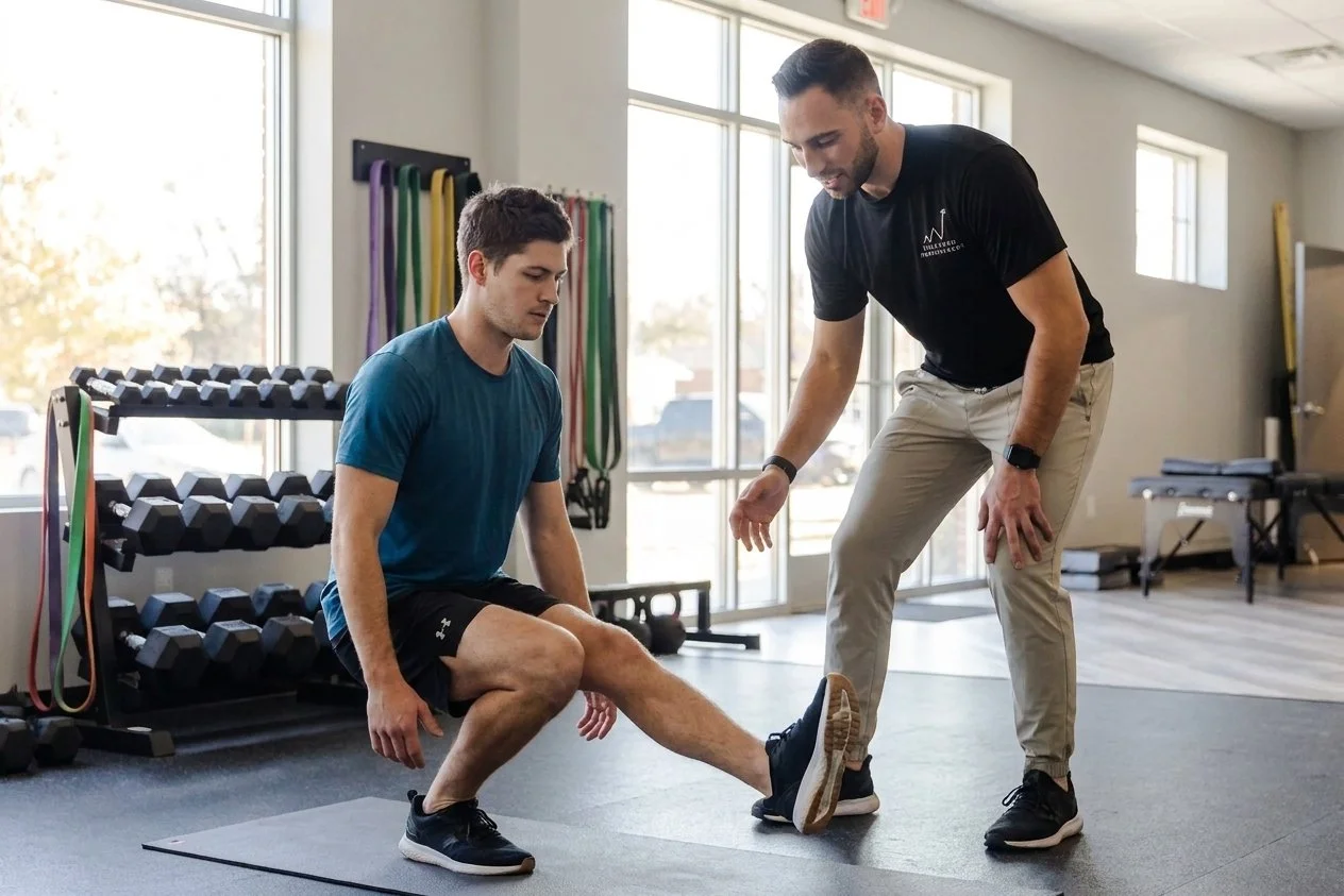 Athlete working with a provider at a performance physical therapy clinic in Greenville, SC during a therapeutic exercise session
