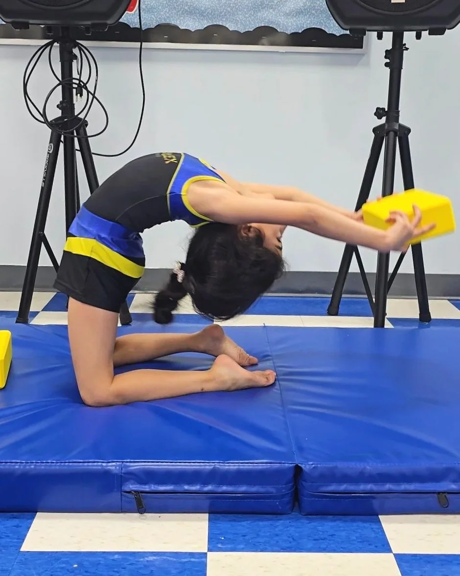 Young gymnast at royal flex gymnastics demonstrating a backbend drill