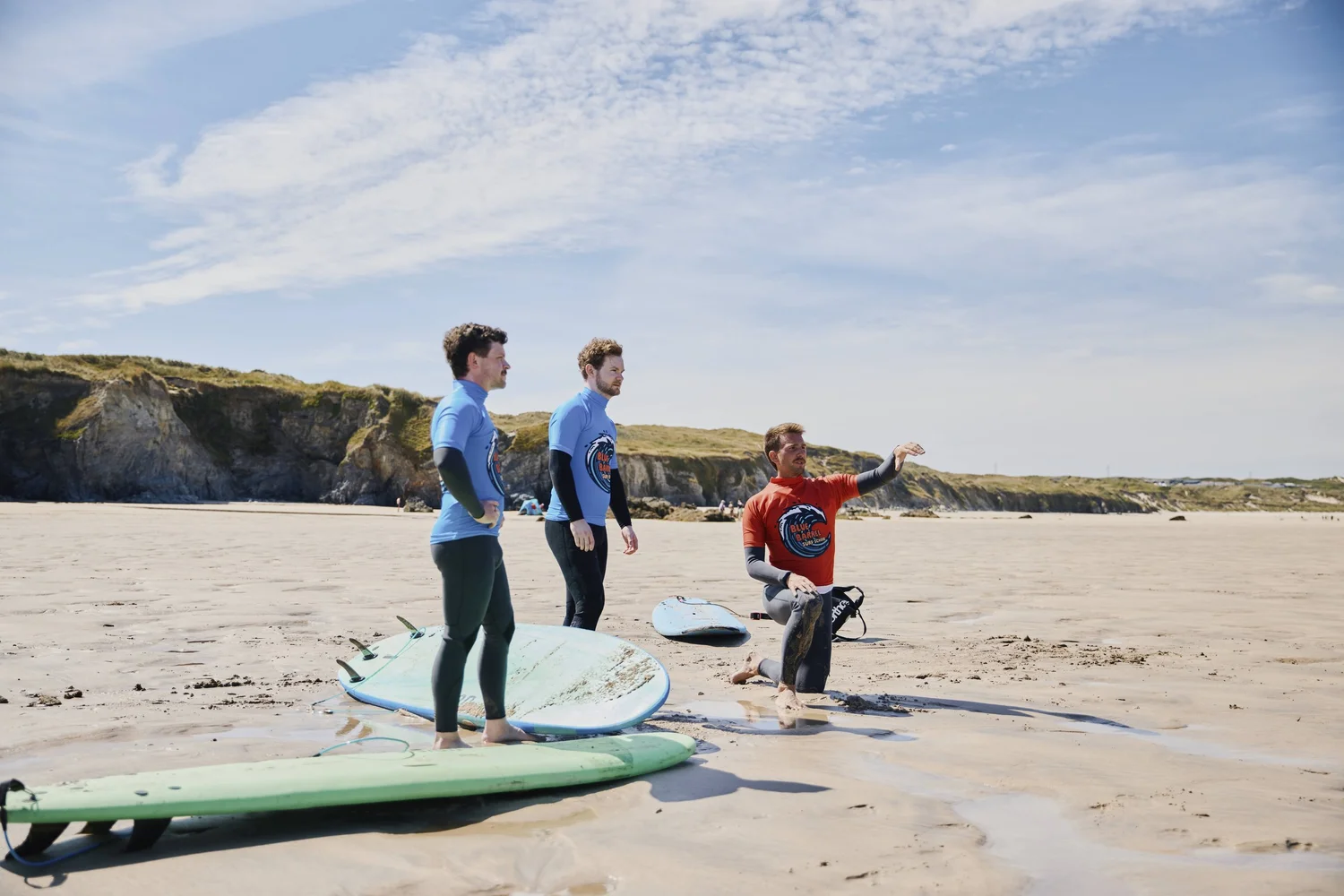 Blue Barrel surf instructor talking a surfer through the waves during a private lesson in Cornwall