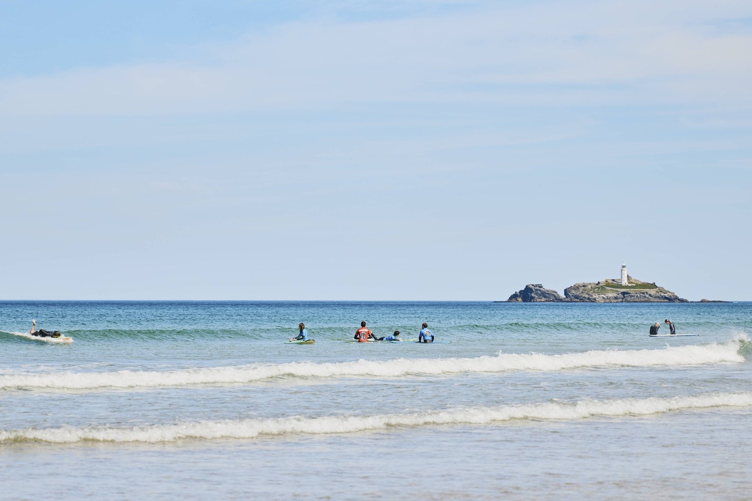 Friends enjoying a private surf lesson in Cornwall, a popular surf gift experience