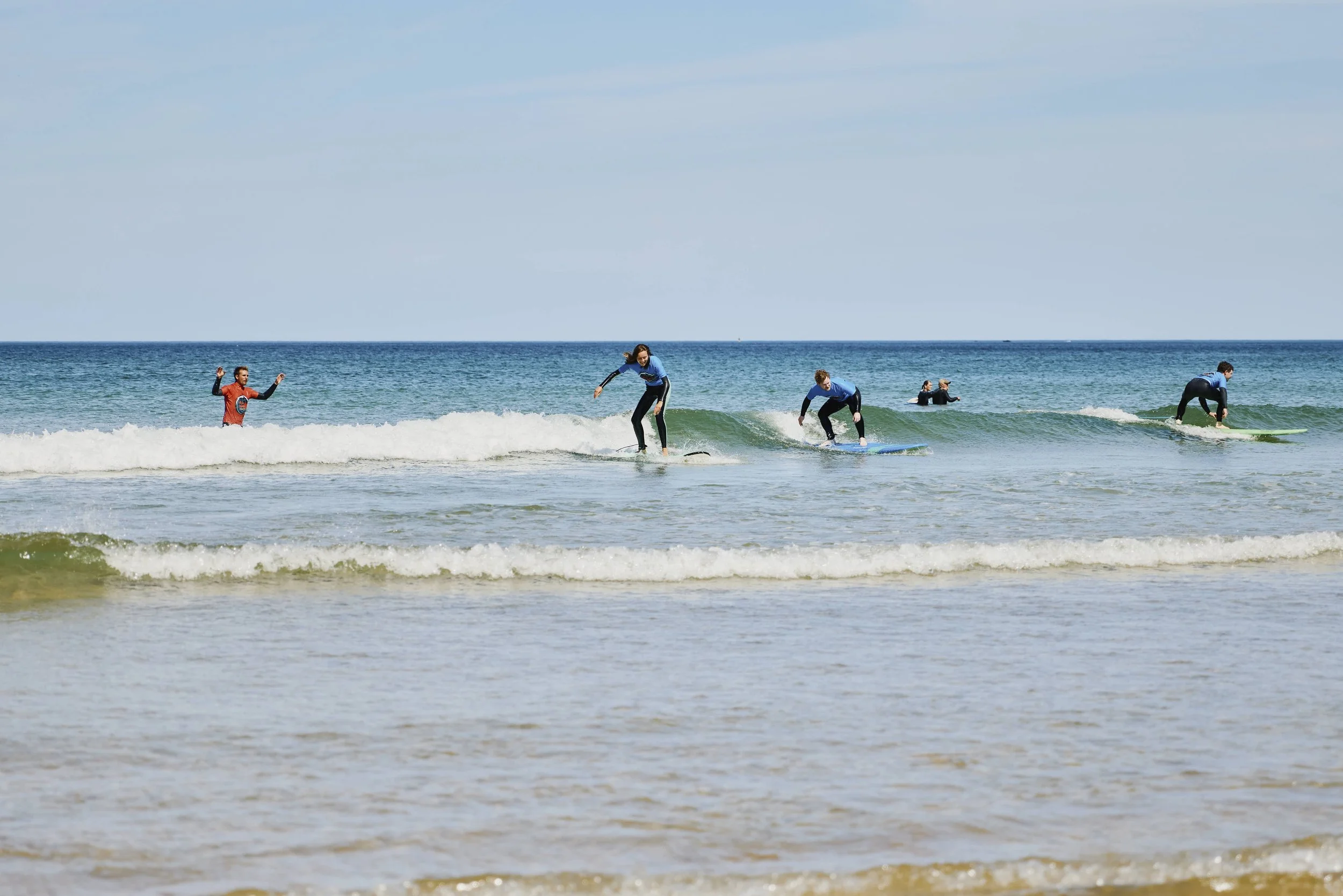 family riding unbroken wave