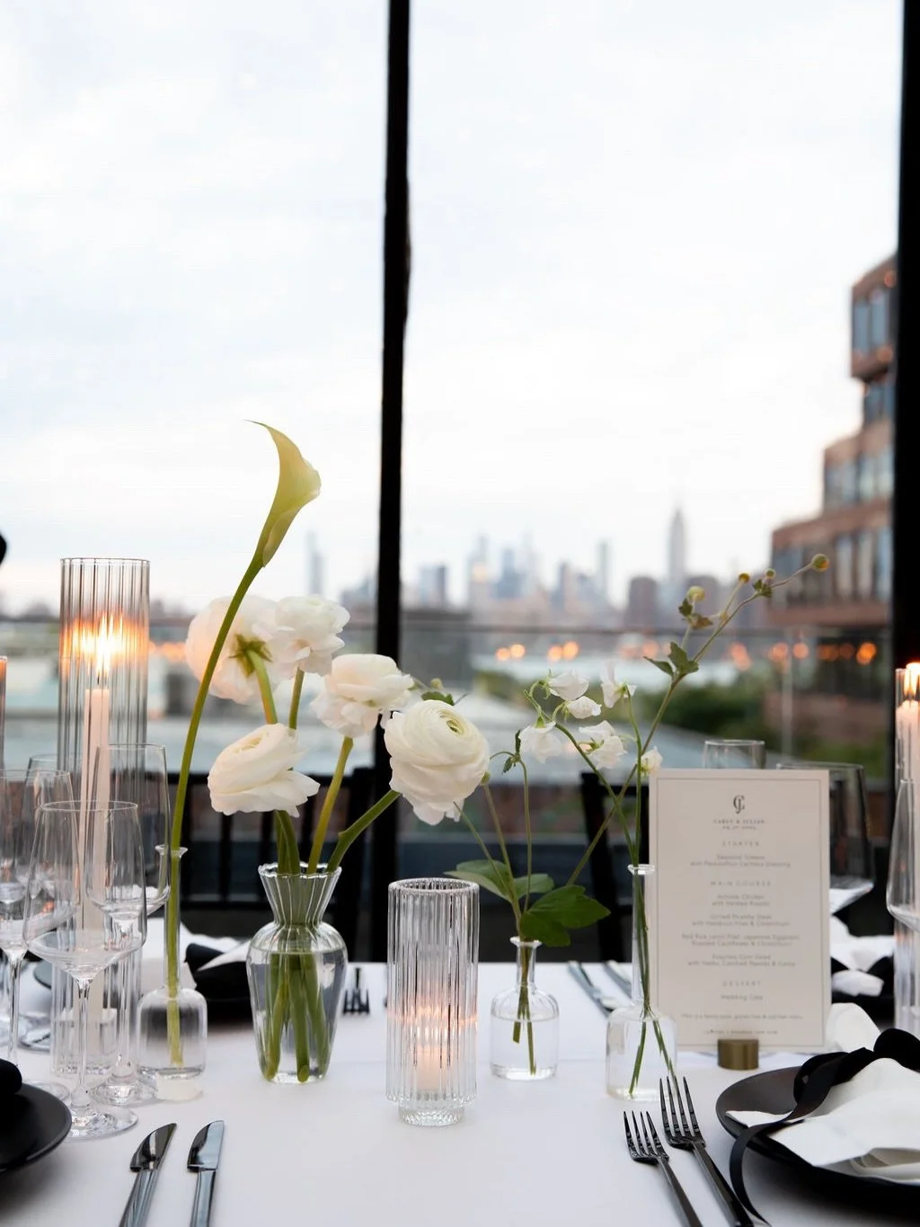 elegance in simplicity for C&amp;J. minimal florals, black &amp; white place settings, hand foiled ribbon place cards with stunning city views. 

a perfect brooklyn night celebrating these two beautiful humans 🖤

2026 couples, save this &amp; follow