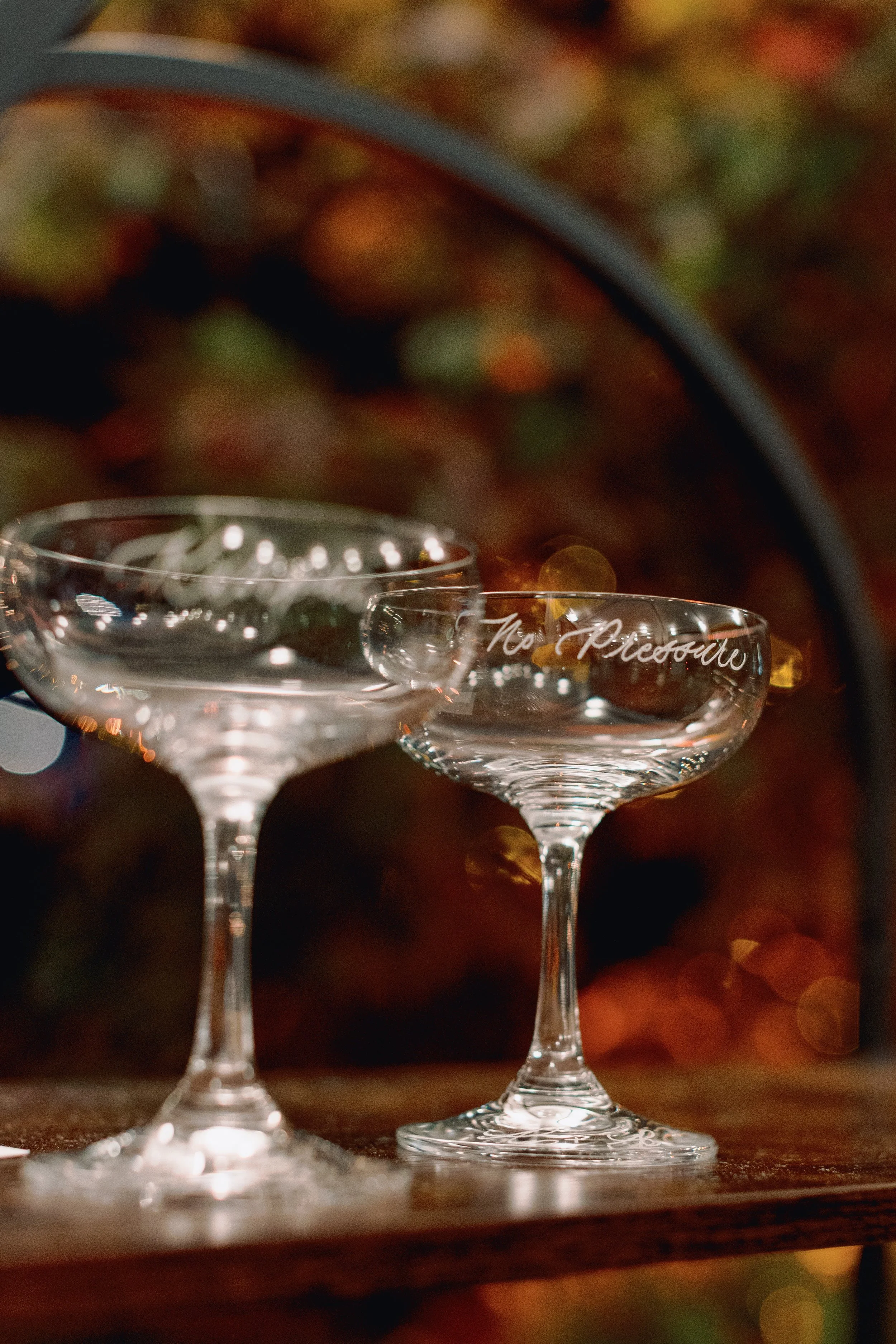 Personalized champagne coupe wedding favors with hand engraved calligraphy