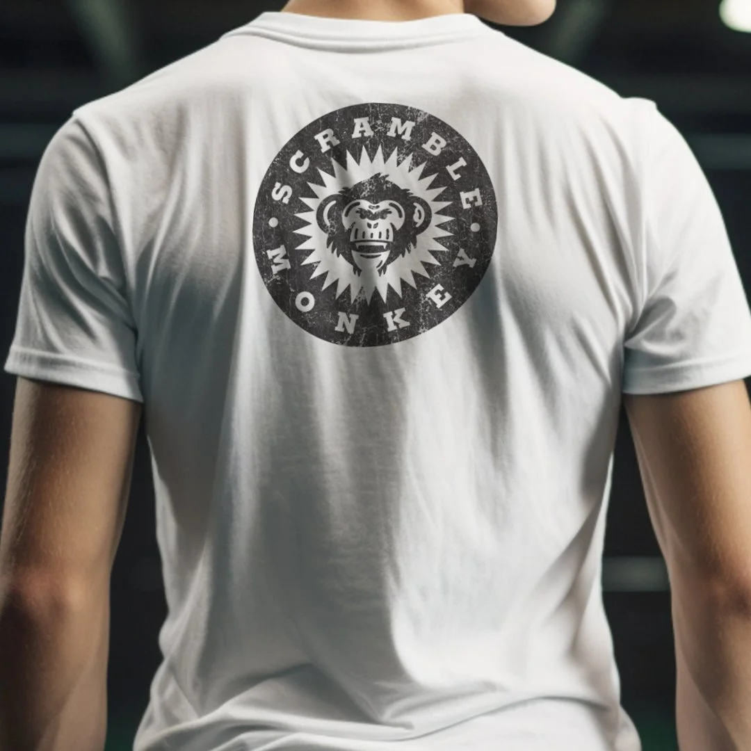 Person wearing a white t-shirt with 'Scramble Monkey' logo featuring a monkey graphic