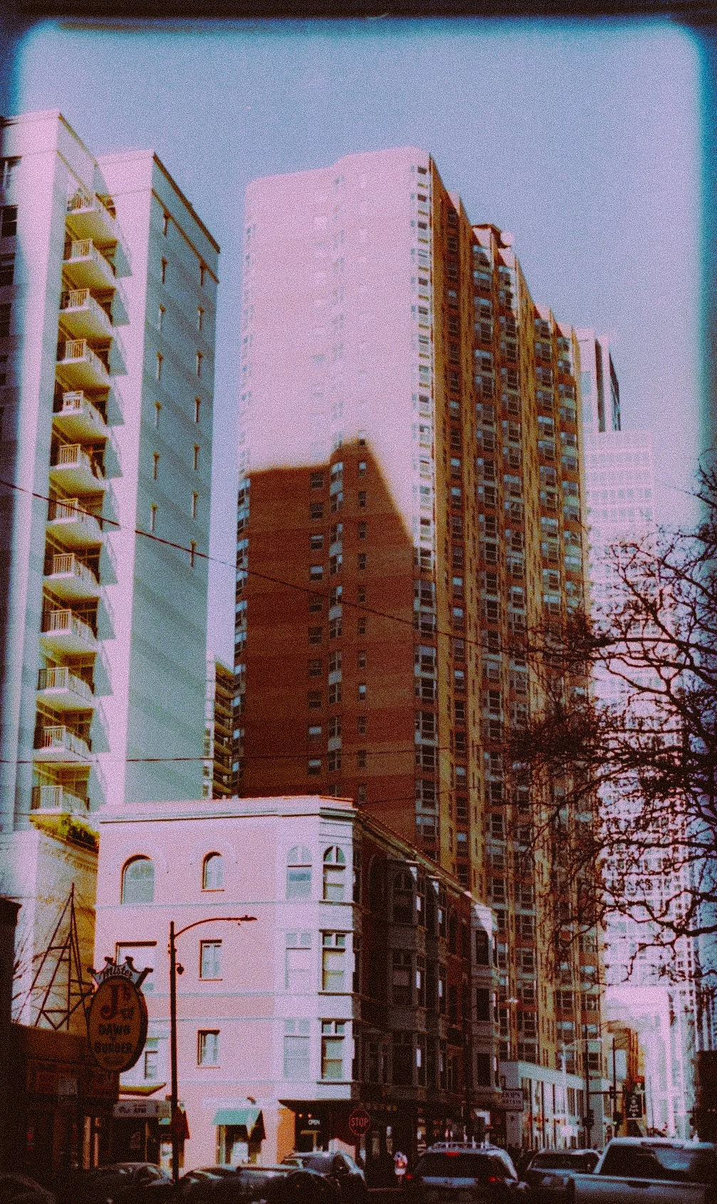 City street with tall buildings and cars in Chicago, featuring faded colors for a vintage look.