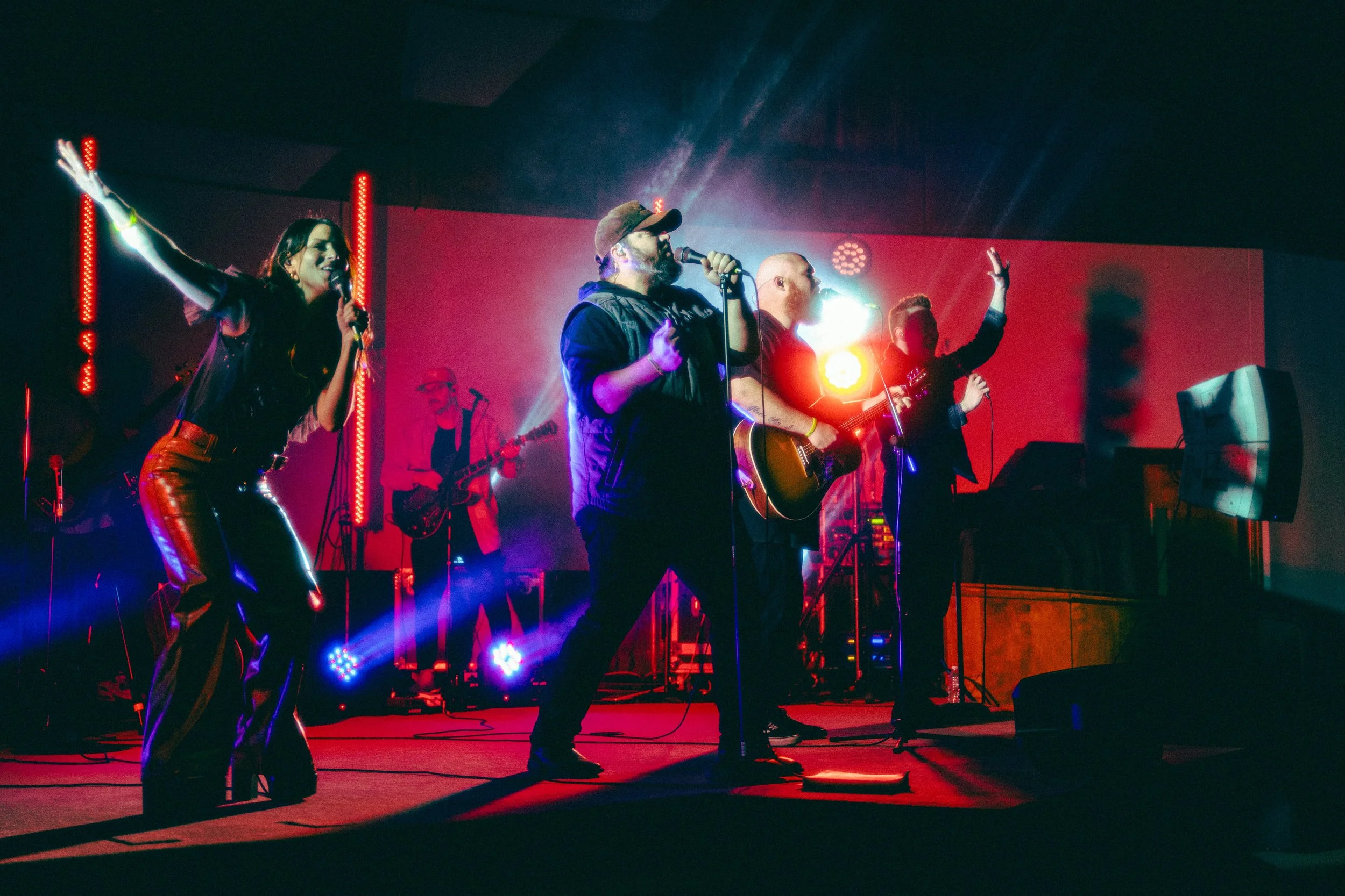 Live music performance with band on stage and colorful lights