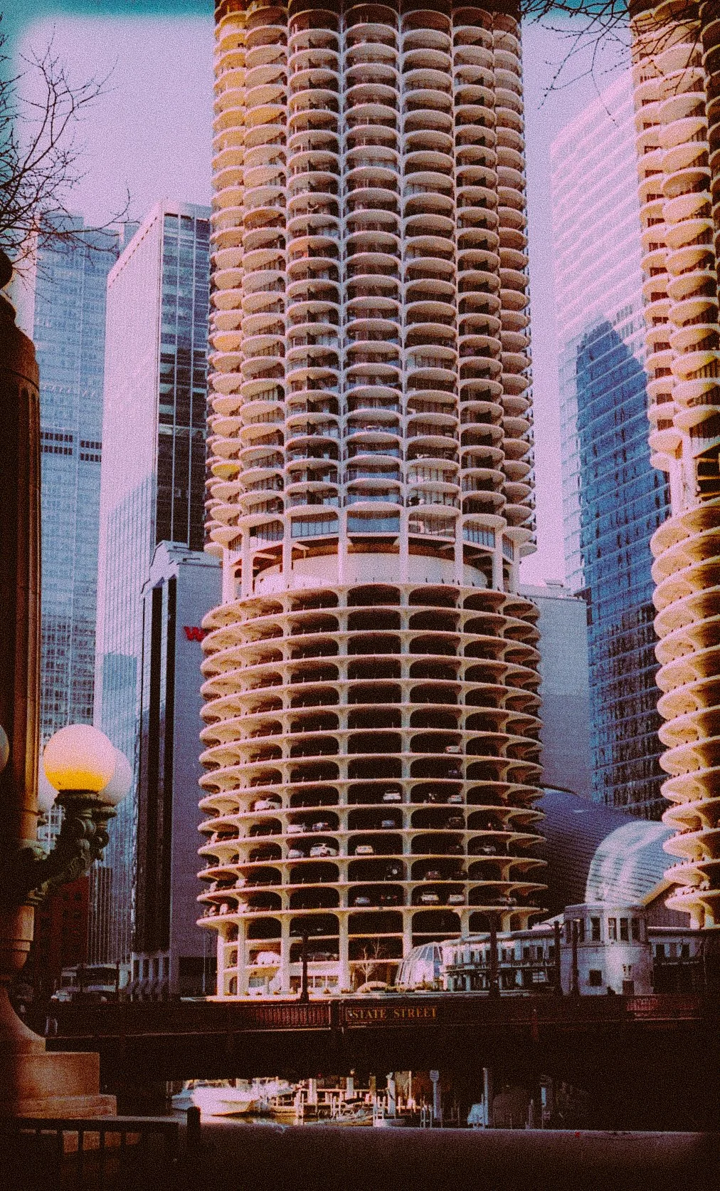 Marina City towers in Chicago with surrounding buildings and a street view.