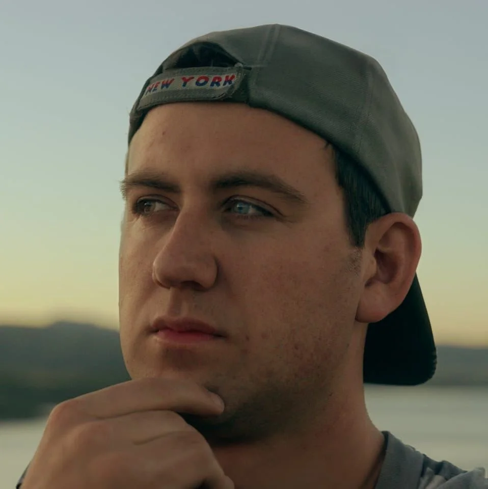 Brian Thiem owner and photographer in a gray baseball cap backwards.