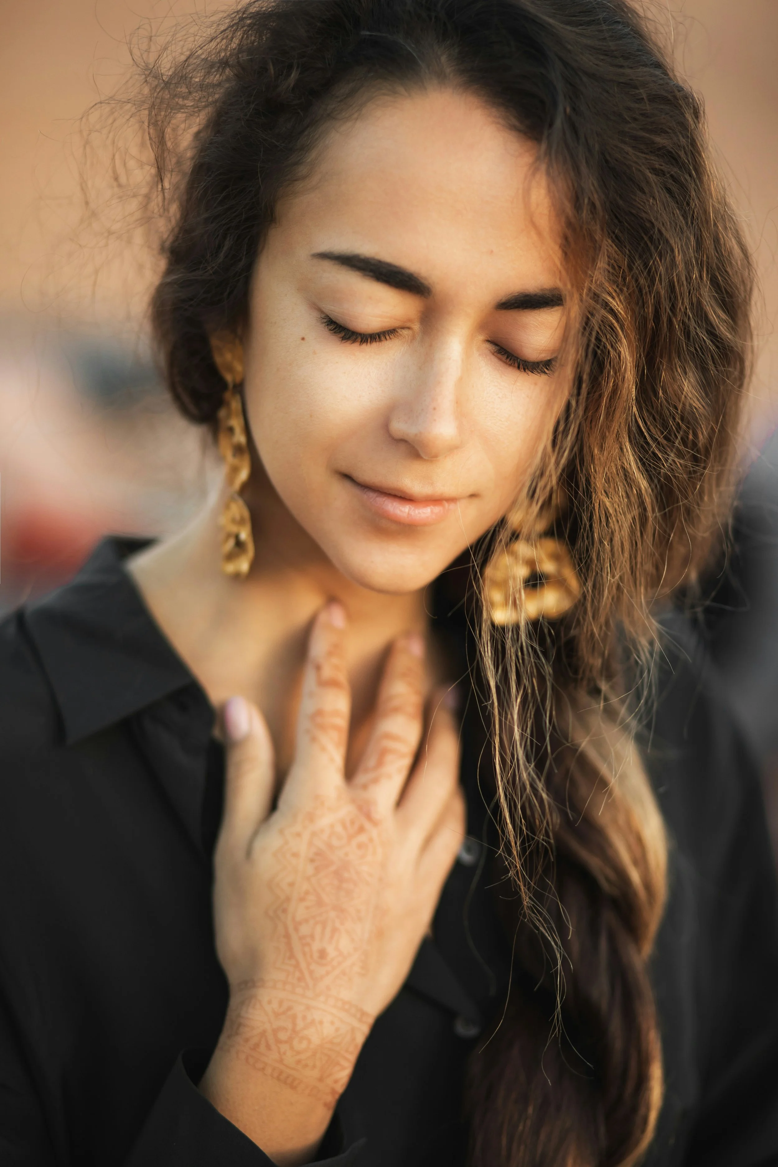 Woman sitting quietly with a hand on her chest noticing overwhelming emotions