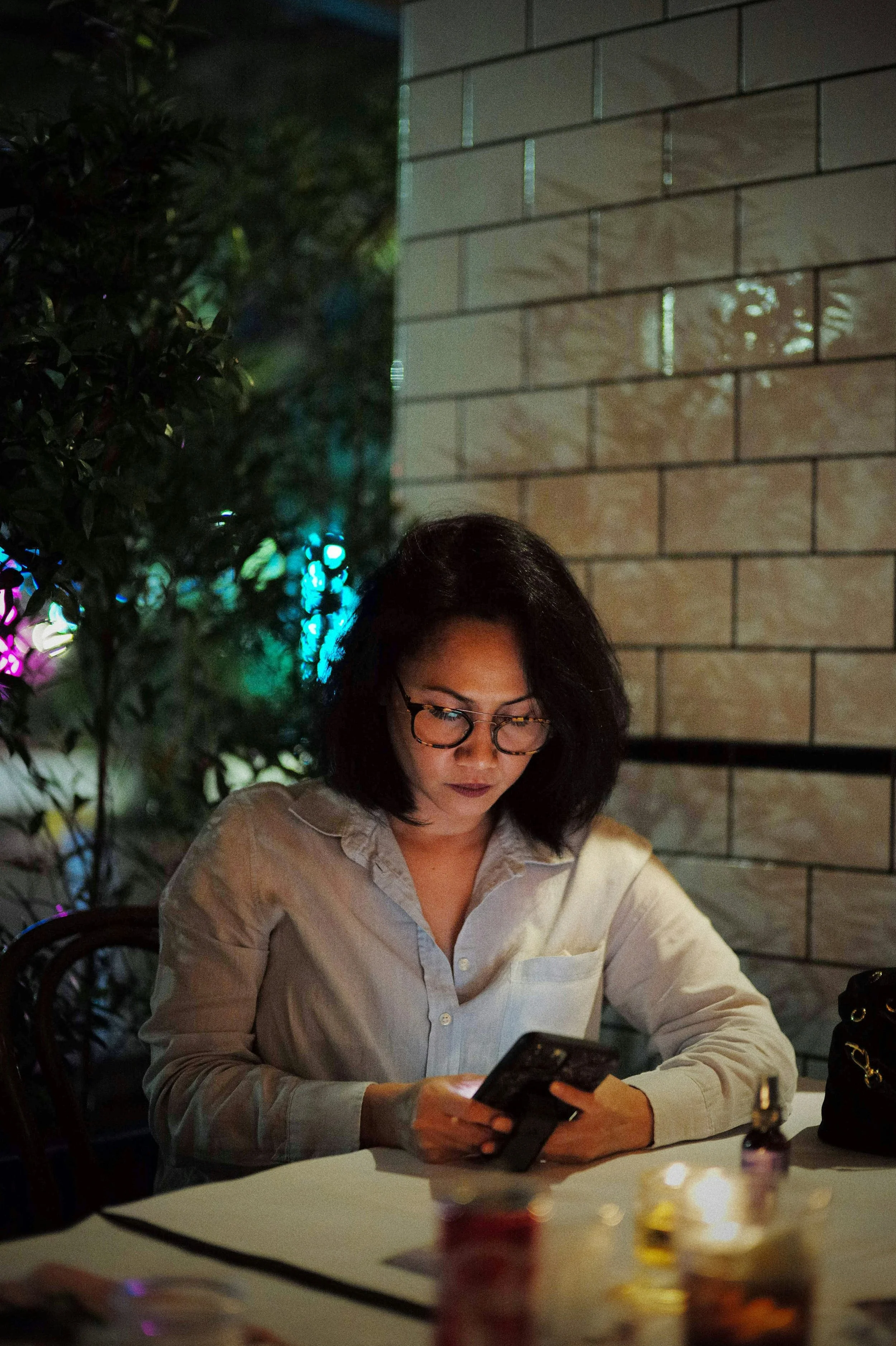 Woman looking at her phone thoughtfully reflecting on identity and belonging