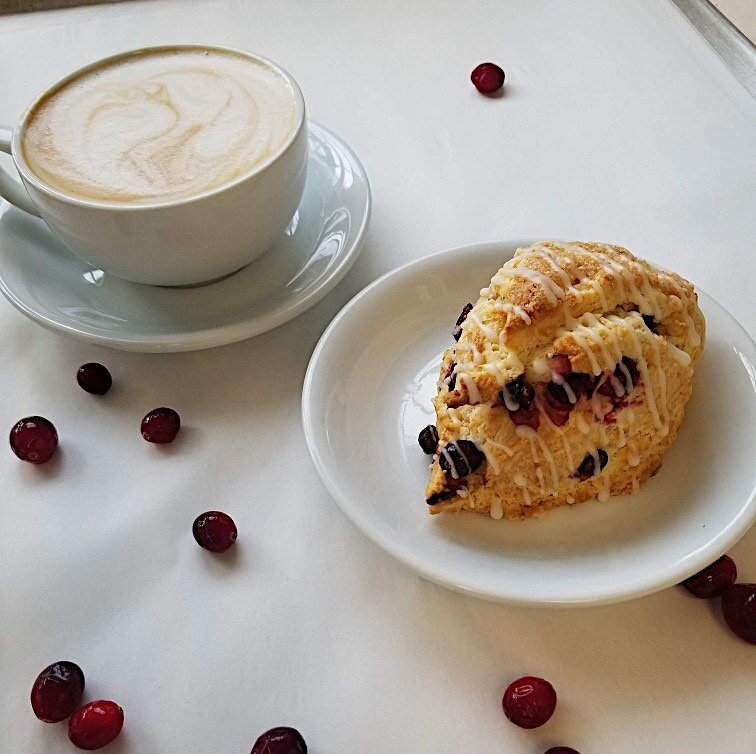 ☕️What better way to get in the holiday spirit than a warm cranberry orange scone &amp; holiday spice latte?? Our cozy speculaas spice is a perfect blend of pumpkin spice &amp; ginger bread , paired with our seasonal scone is gaurenteed to make your 