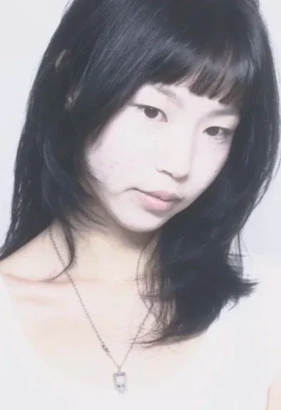 A young woman smiling.