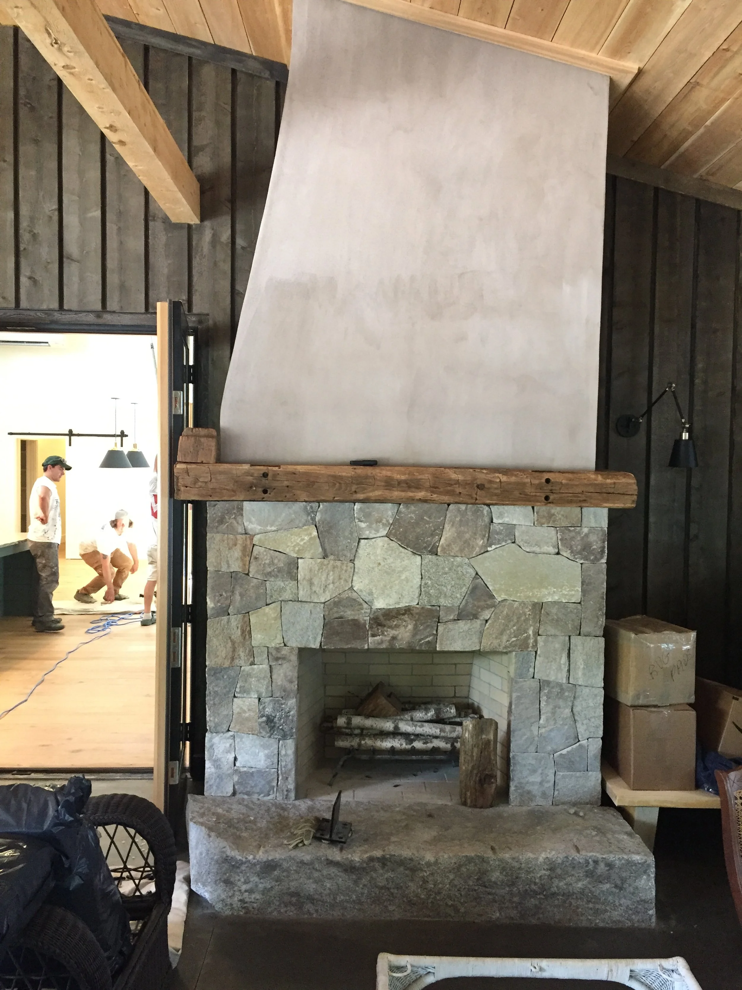 Stone fireplace with reclaimed wood mantle