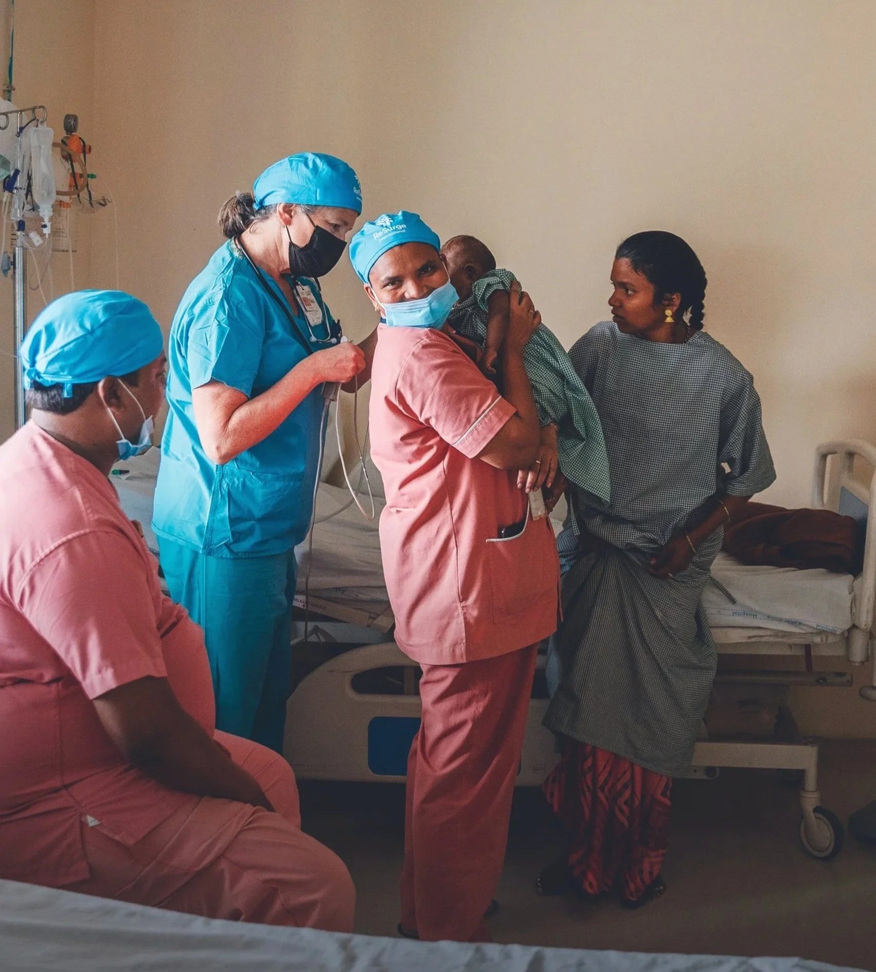 A ReSurge trainer helping patients along with the local medical staff.
