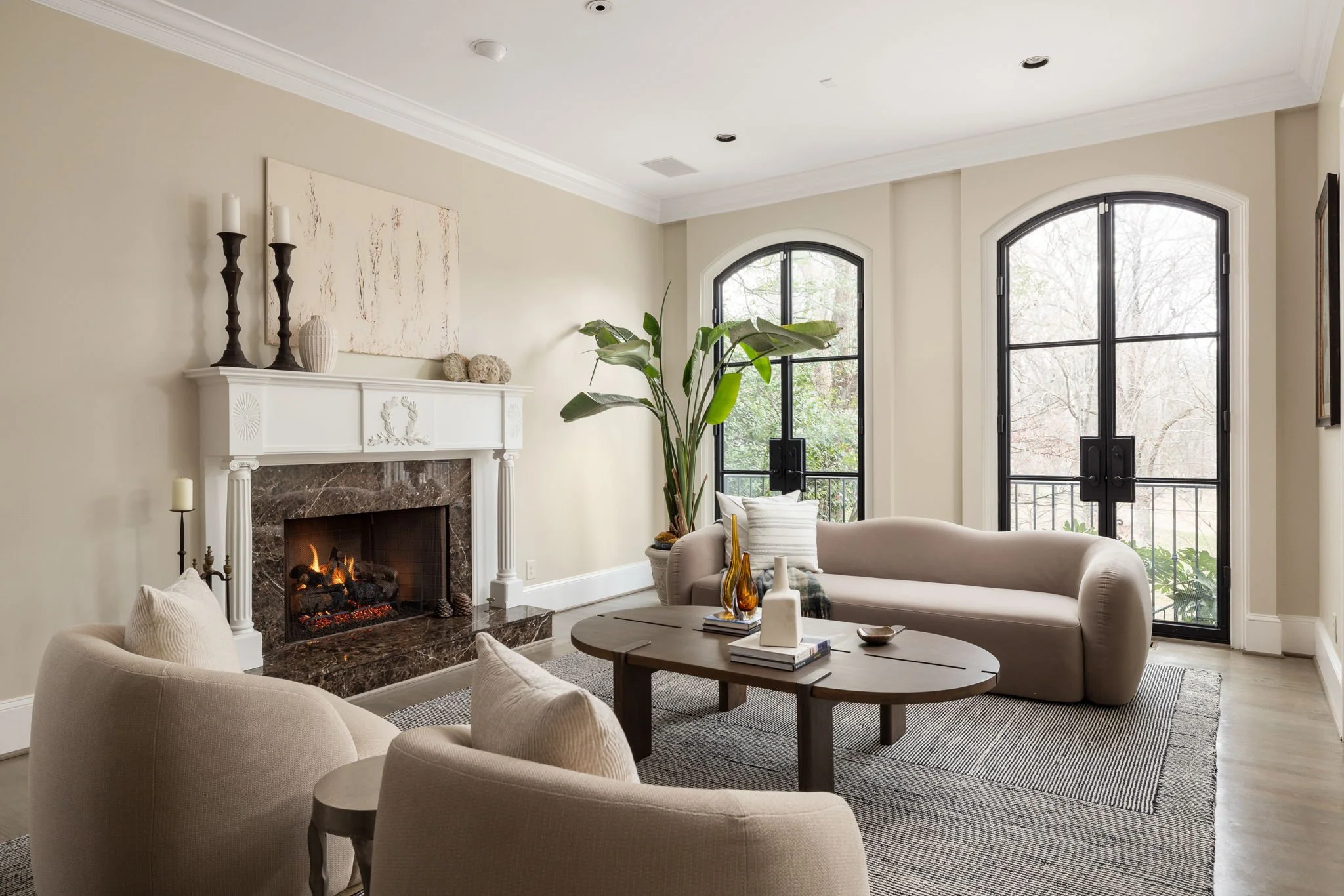 Large steel windows let the light into this modern living room with fireplace.