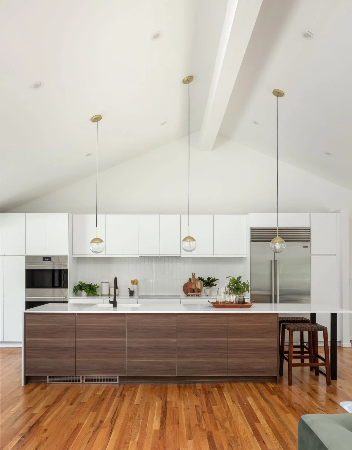 Vaulted ceilings and pendant lights draw your eye towards this modern kitchen.