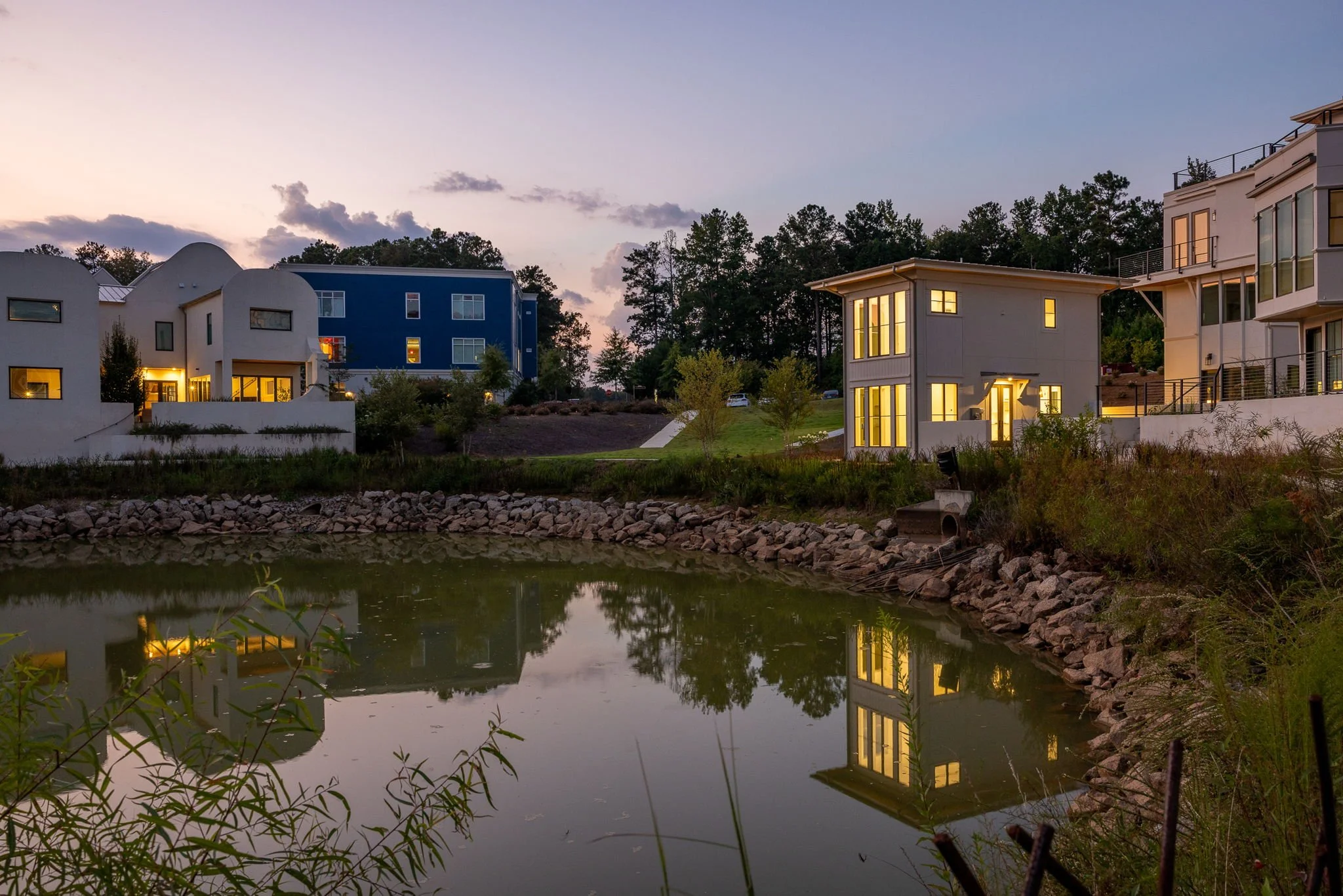 Dusk view of lakeside townhomes and houses in the farm community of Serenbe.