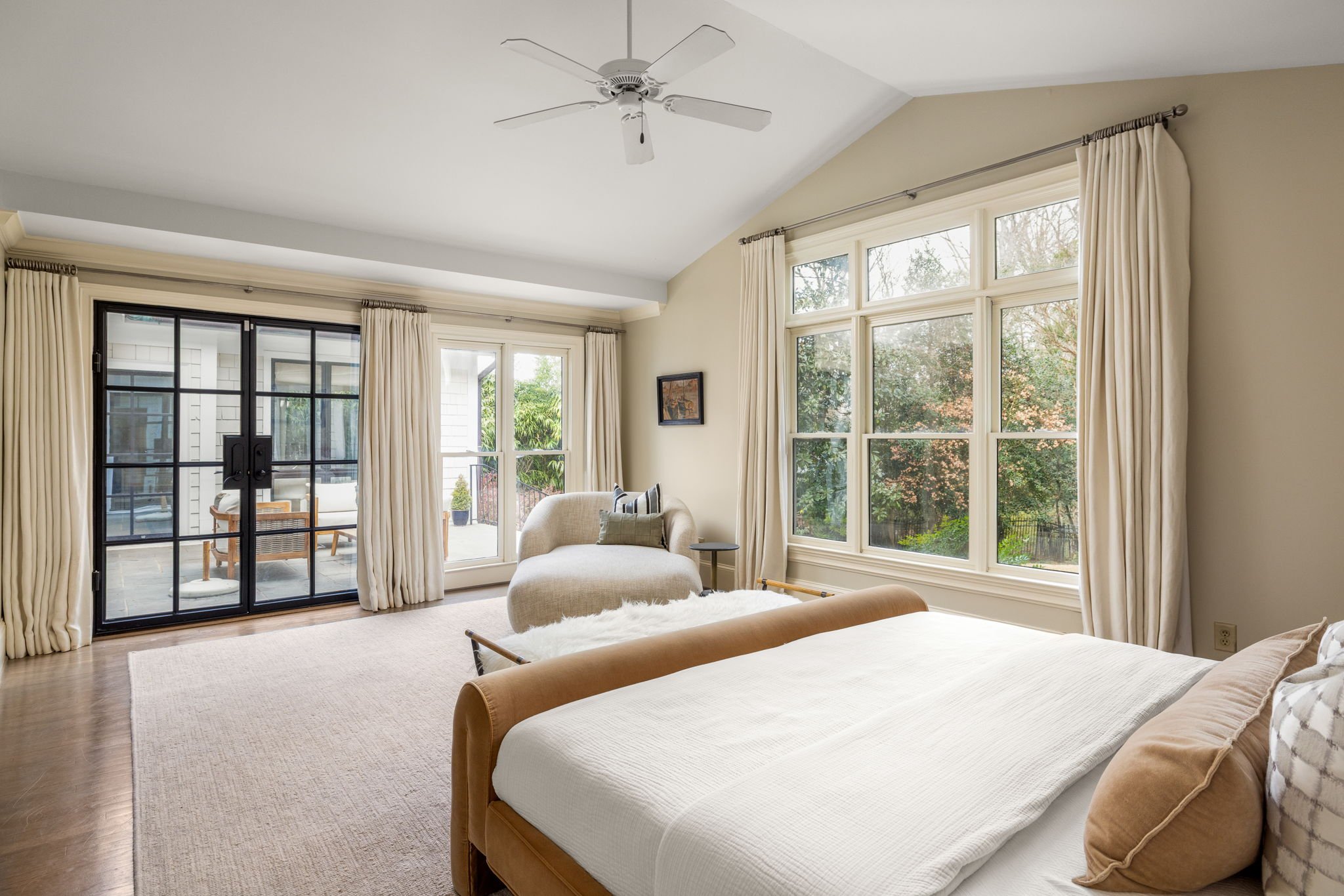 A primary bedroom full of natural light.