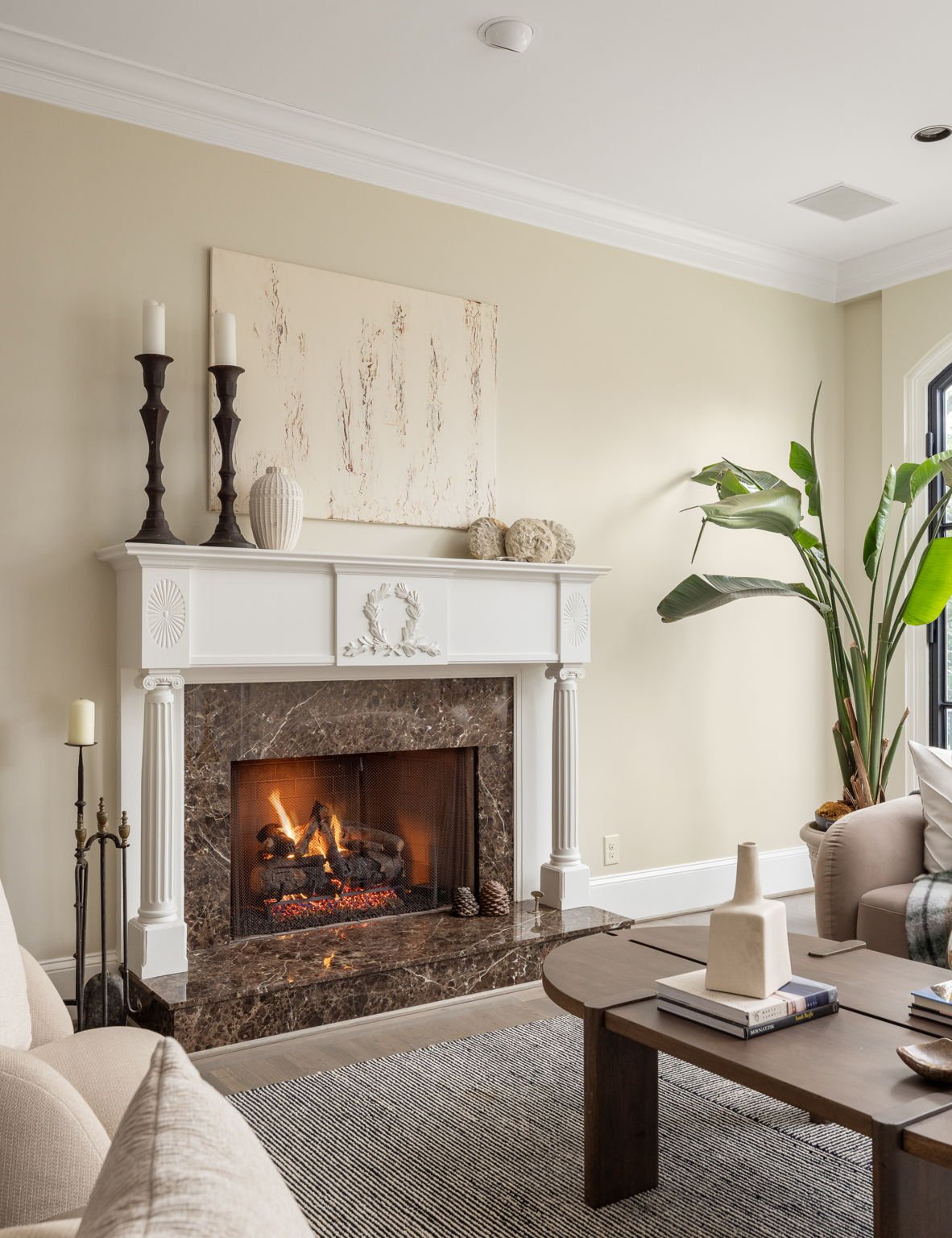 A cozy fireplace burns in this modern Atlanta living room.