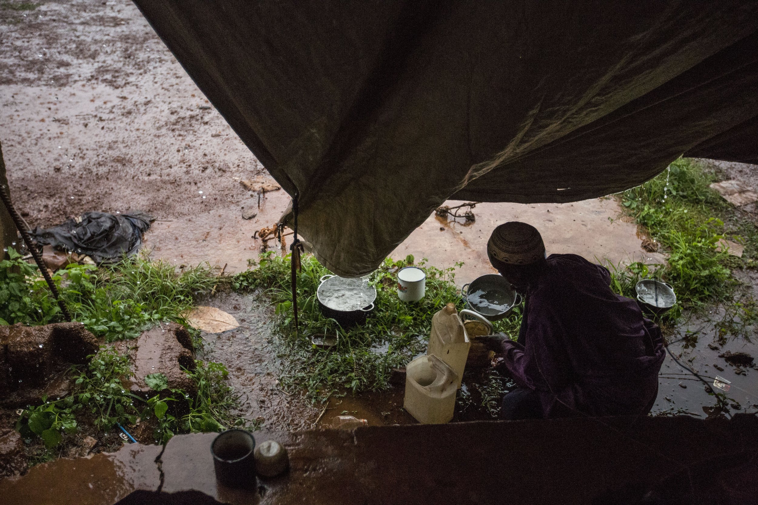 Nostalgia for nomadic herding life and natural fresh water makes community members gather rainfall despite availability of potable water on the site.