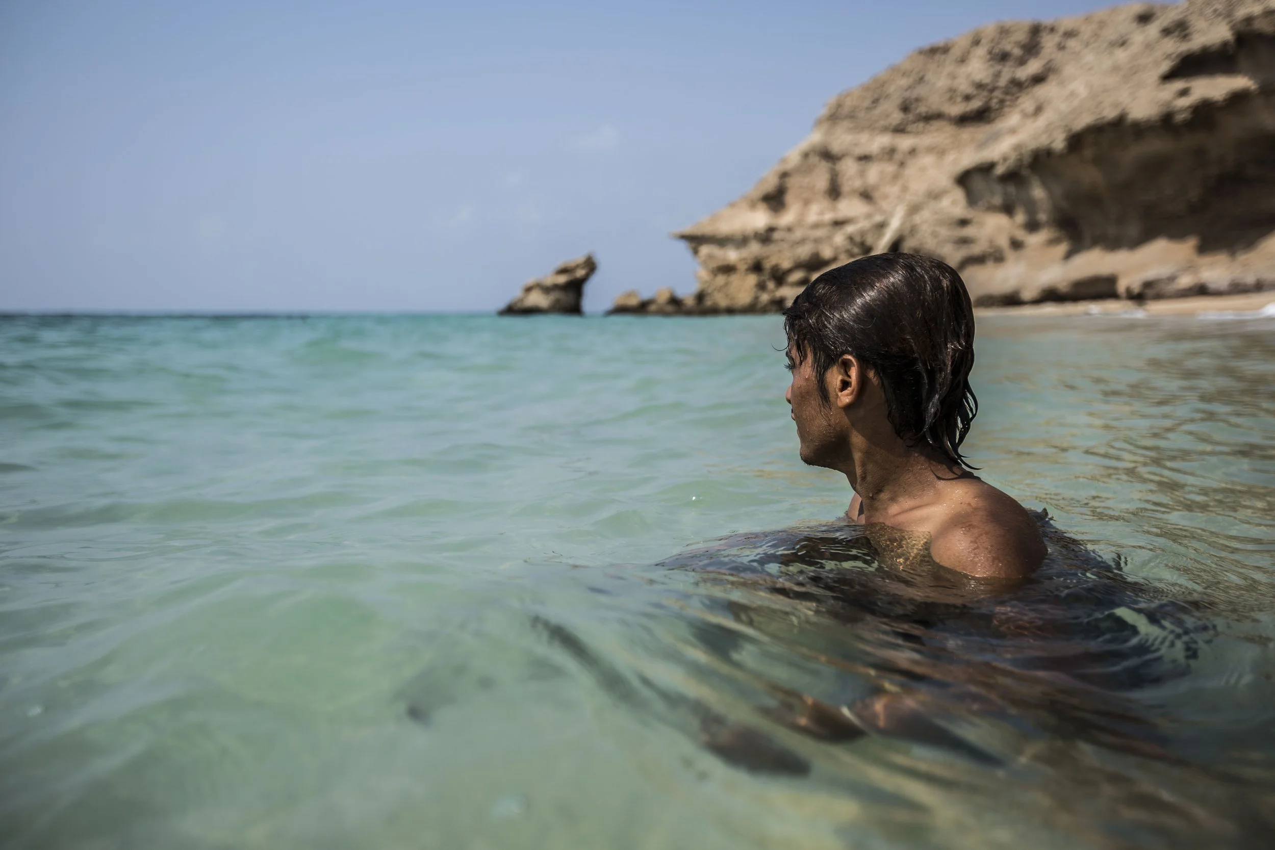 Yemeni refugee Ali Abulrahman Albaguess, 19, takes a swim nearby the camp on the coast of Obock, Djibouti. Isuued from a fishermen family, Ali says he comes to the sea to grieve.