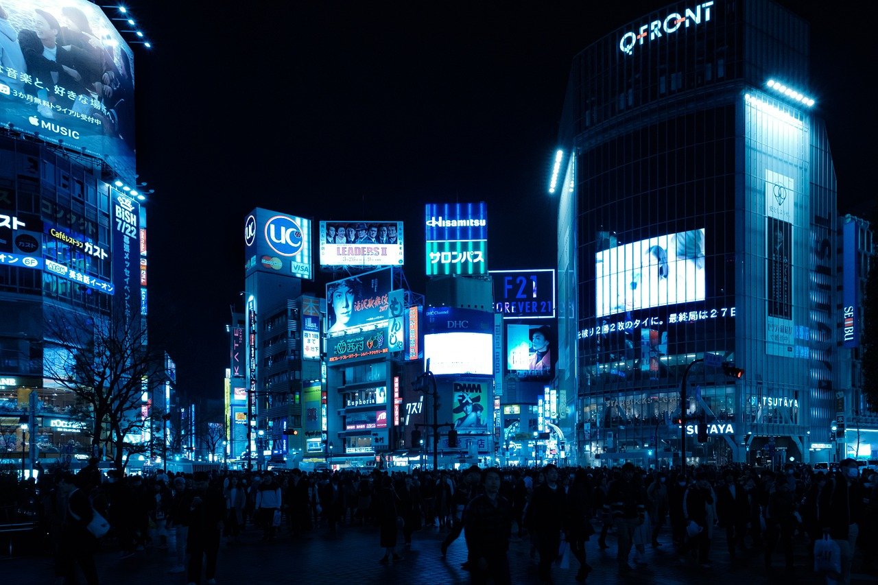 Tokyo at night, illuminated by vibrant neon lights and futuristic technology, showcasing the city's modern skyline and high-tech atmosphere.