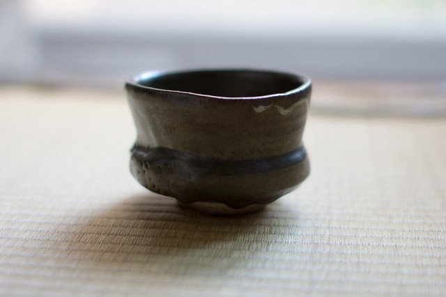 A Kyoto ceramic bowl showcasing the essence of wabi-sabi, with its rustic, imperfect design, subtle glazes, and natural textures, reflecting the beauty of simplicity and transience.