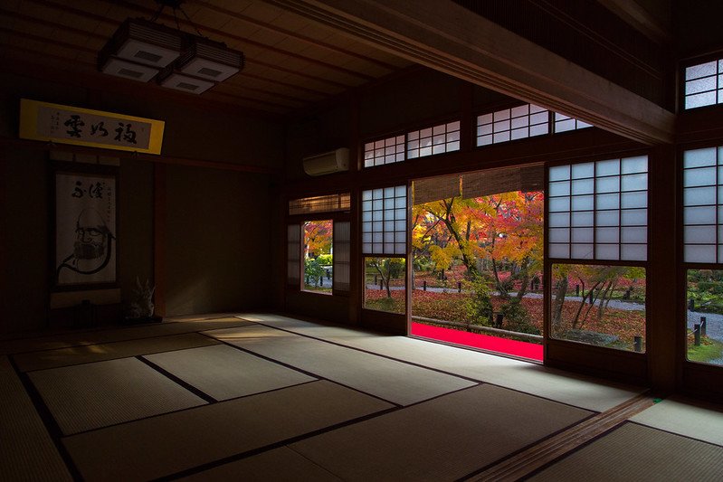 Traditional Japanese interior with tatami mats, sliding doors, and minimalist decor.