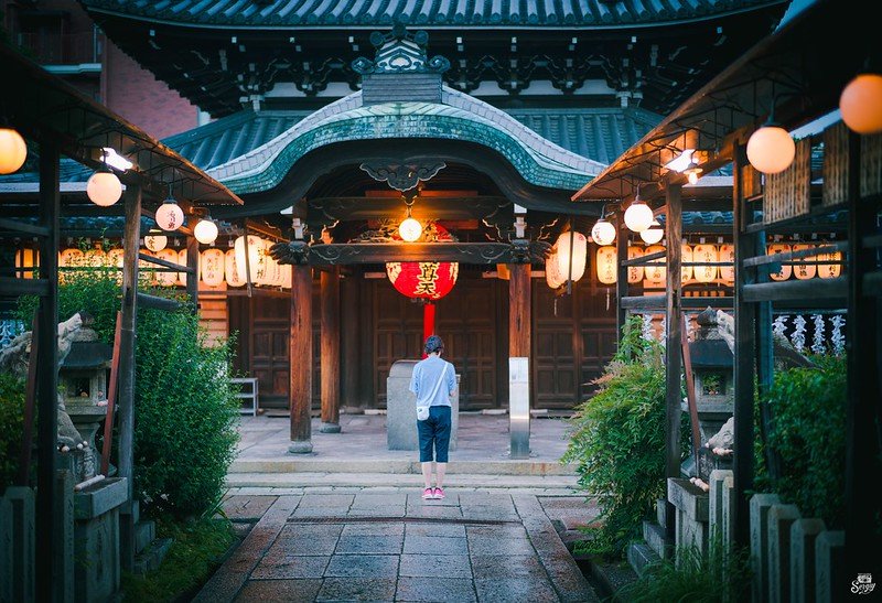 Traditional local temple in Gion, Kyoto, surrounded by lush greenery.