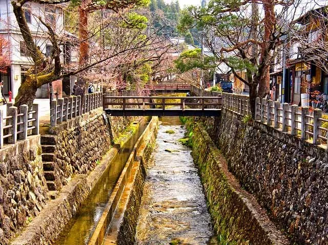 A small river in Takayama, flowing through a peaceful landscape.