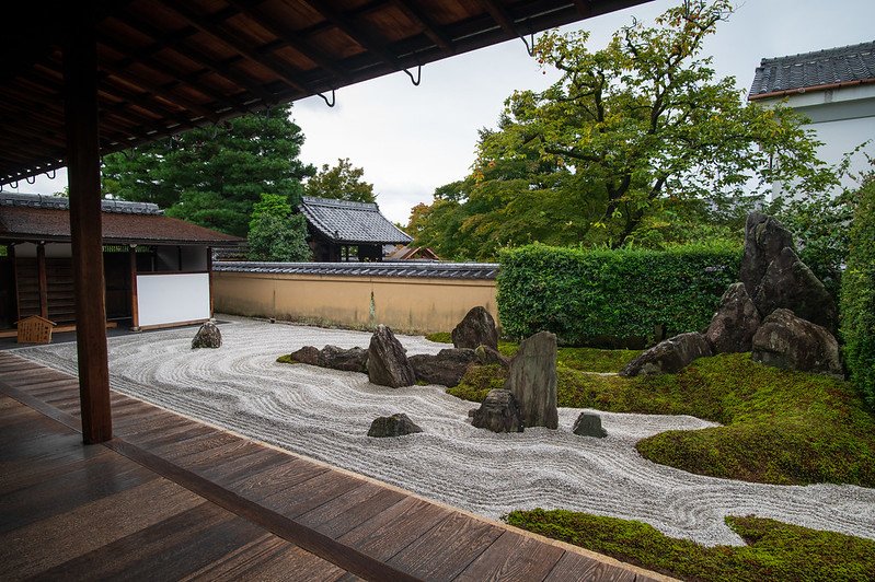 An arrangement of rocks in a garden at Daitokuji, showcasing traditional Zen design with carefully placed stones on a raked gravel bed.