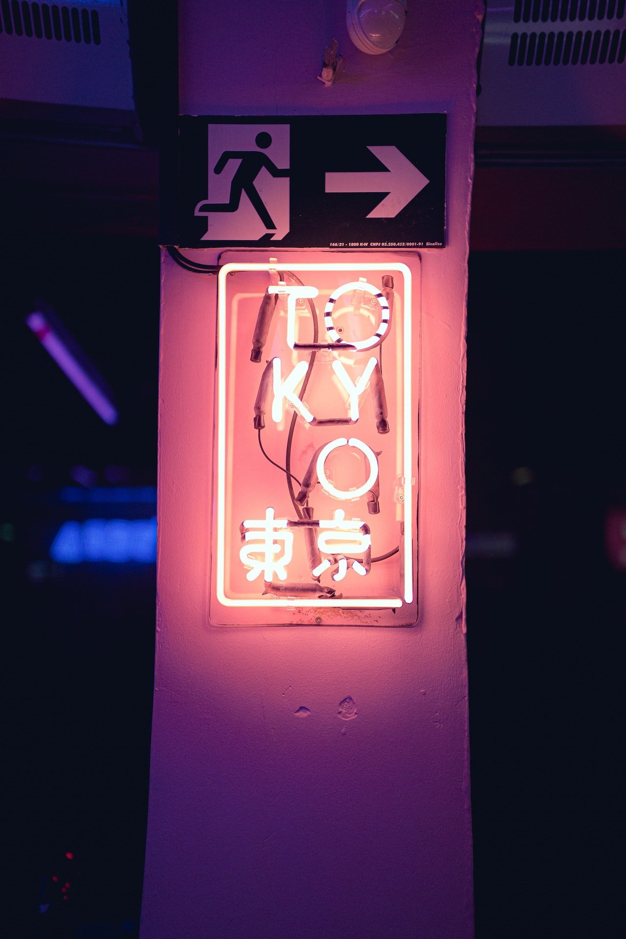 Neon light sign displaying the word 'Tokyo,' glowing brightly in a vibrant urban setting, capturing the city's dynamic nightlife.