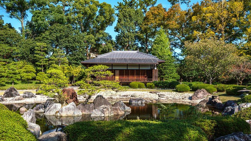 A beautiful garden at Nijo Castle in Kyoto, featuring traditional Japanese landscaping, tranquil ponds, and meticulously arranged plants, offering a serene and peaceful atmosphere.