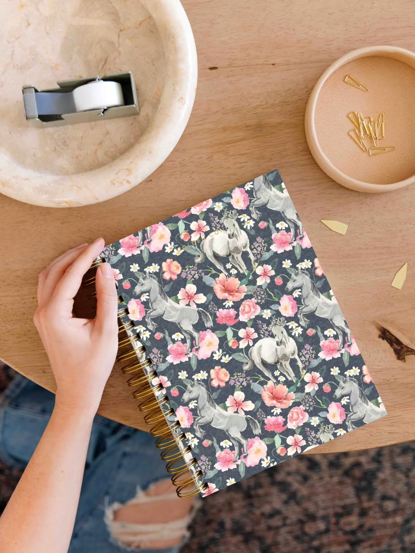 This hand-painted watercolor surface pattern design of florals and horses is my submission for the Golden Coil planner cover.

These horses move freely through an early spring garden. The spacing of the florals keeps the eye moving across the pattern