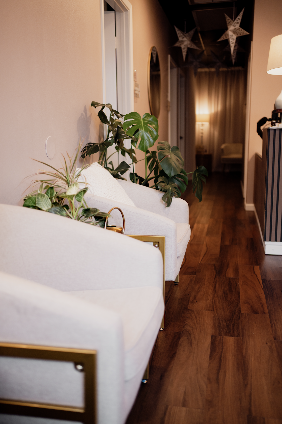 The minimalist reception and waiting area at Bliss Studio, featuring comfortable seating and natural greenery.