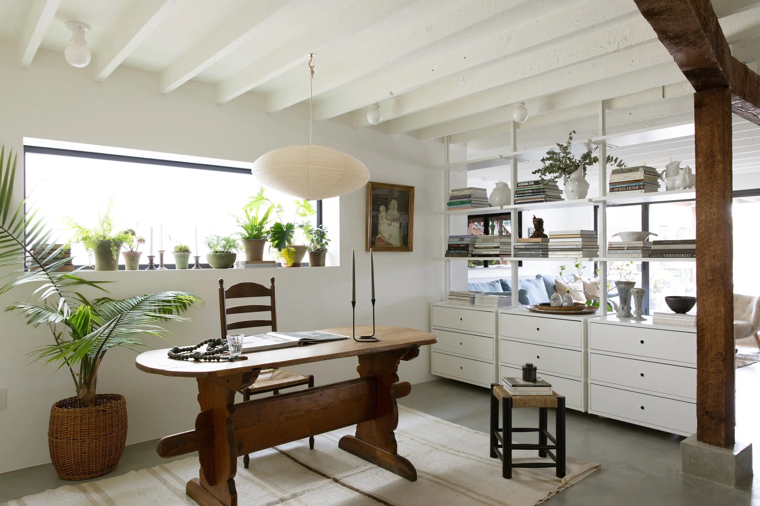 View of dining area with room dividing shelving.