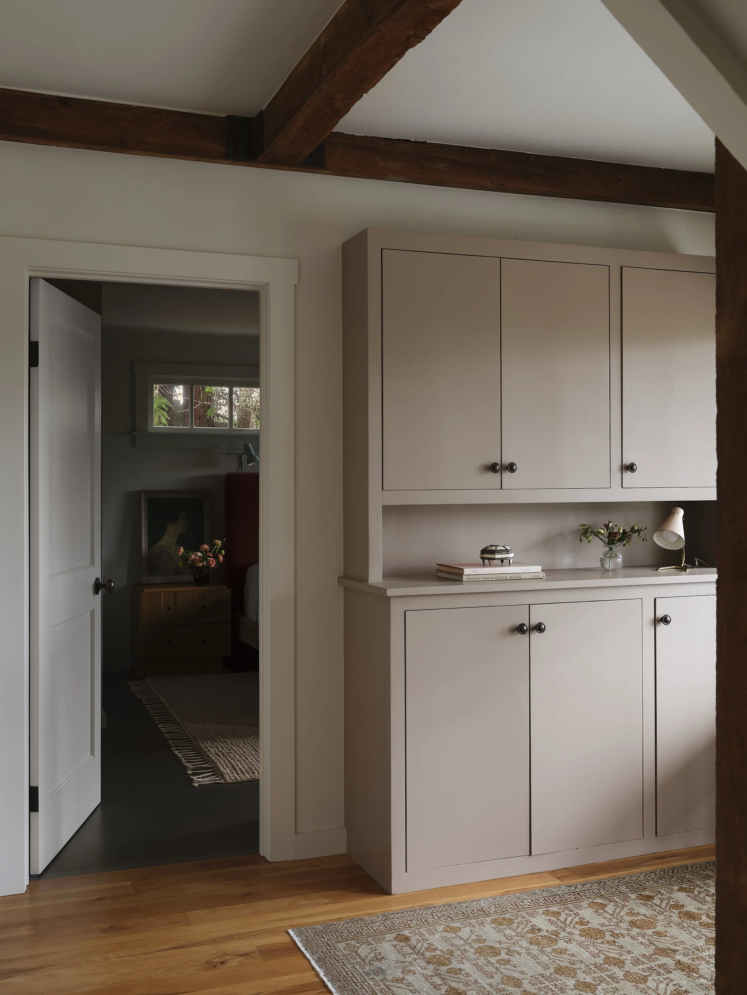 Cabinets and an open door into the bedroom.