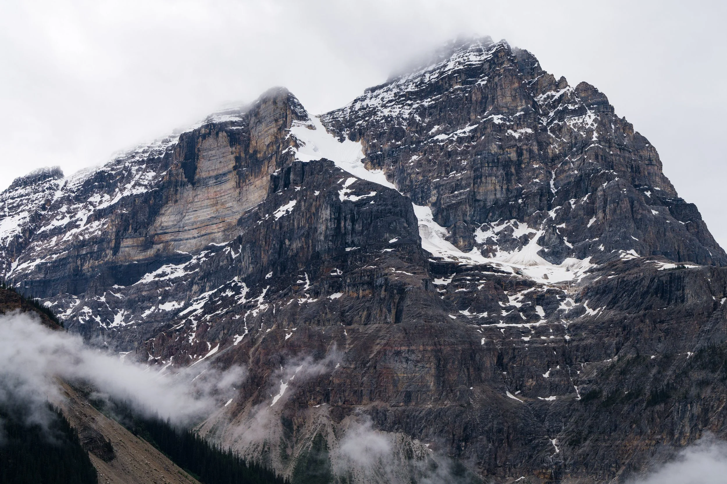 Snow-capped mountains shrouded in clouds