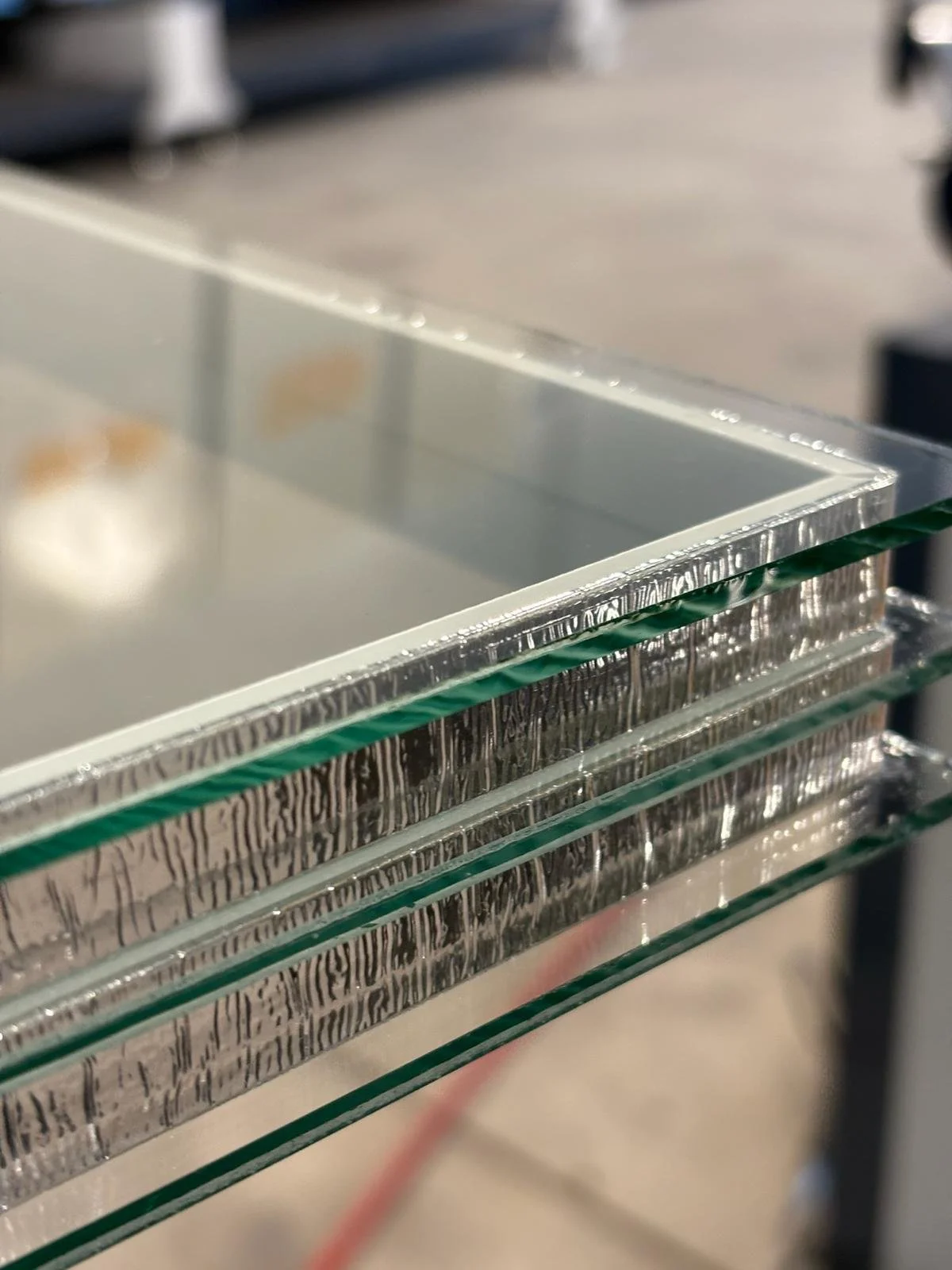 Insulated glass unit cross-section showing aluminum spacer bar and desiccant, manufactured in Ontario.
