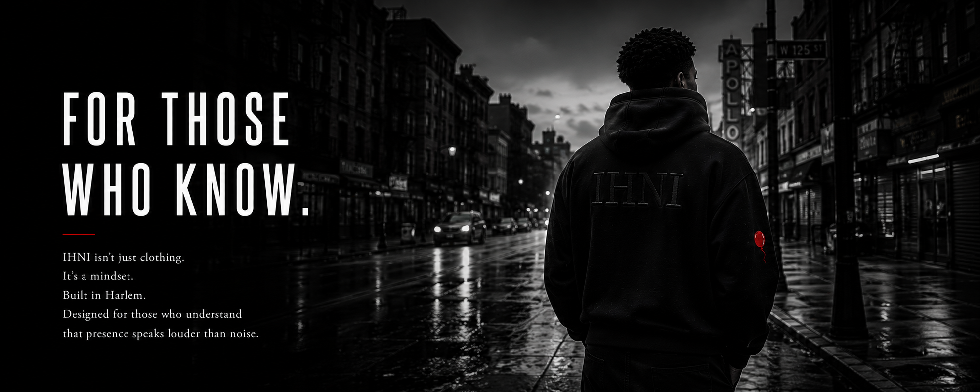 Black and white photo of a man with a hoodie, standing on a wet city street at dusk, with illuminated buildings and cars in the background, and a red balloon on his sleeve. Overlaid text reads 'For Those Who Know. IHNI isn't just clothing. It's a mindset. Built in Harlem. Designed for those who understand that presence speaks louder than noise.'
