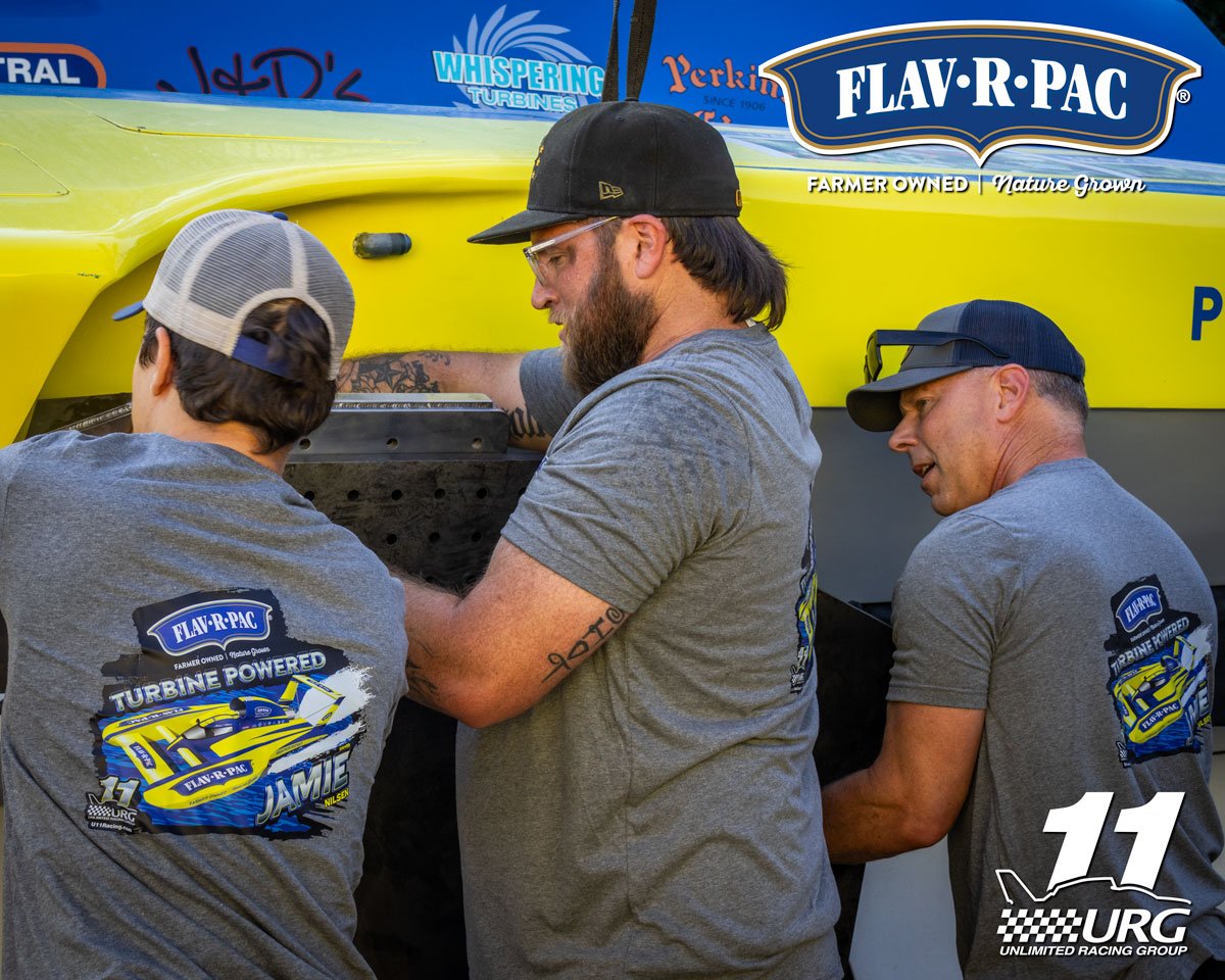 U-11 Miss FLAV-R-PAC crew members Jaydin, Ben and Jay get the skid fin mounted on its bracket. The skid fin is 3 ft x 3 ft, is made of hardened 4340 steel and is 325 pounds. The skid fin allows the boat to turn in an arc to the left at speed, The rac